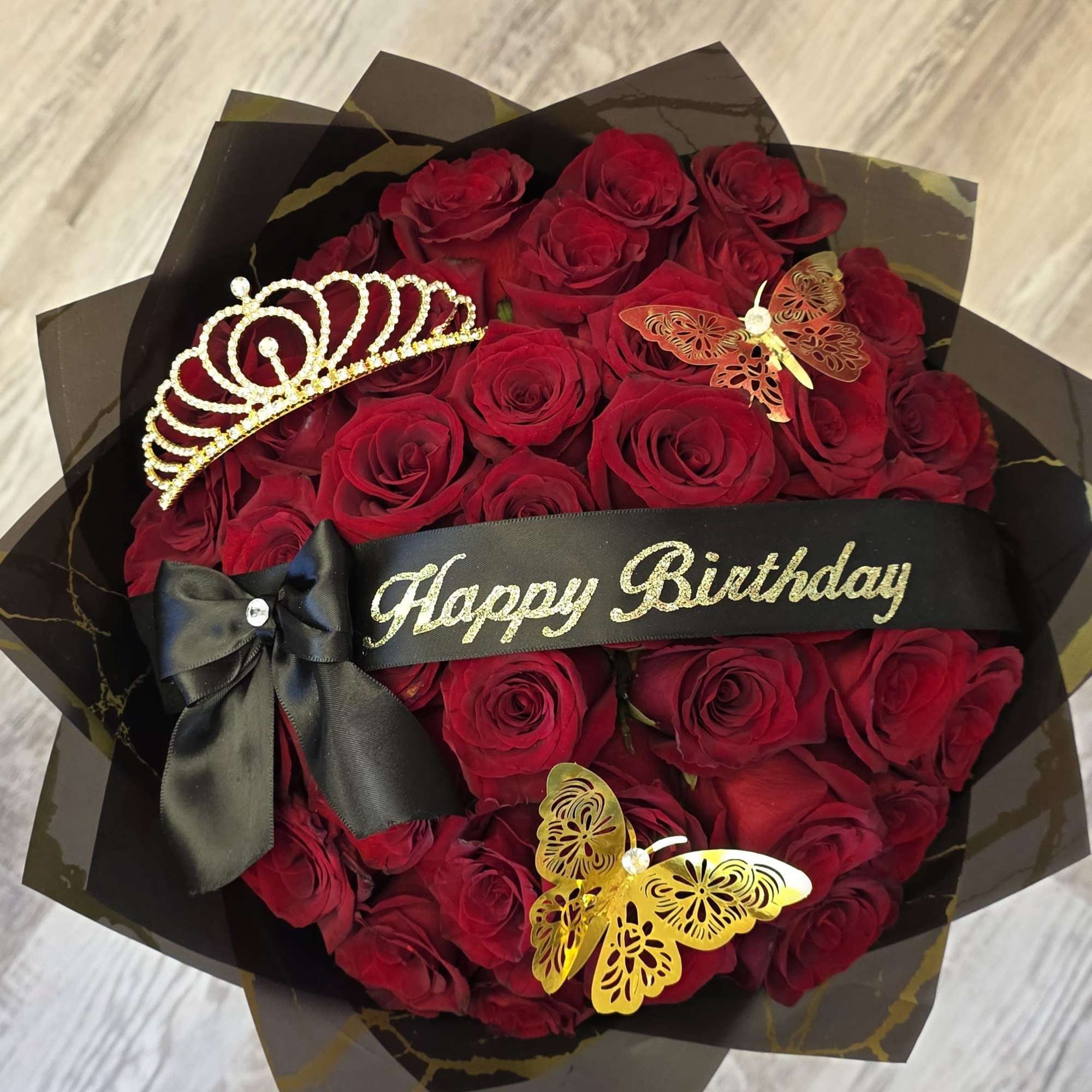 Our 25/50/75 Stem Rose Bouquet with custom banner, crown and butterflies delivers