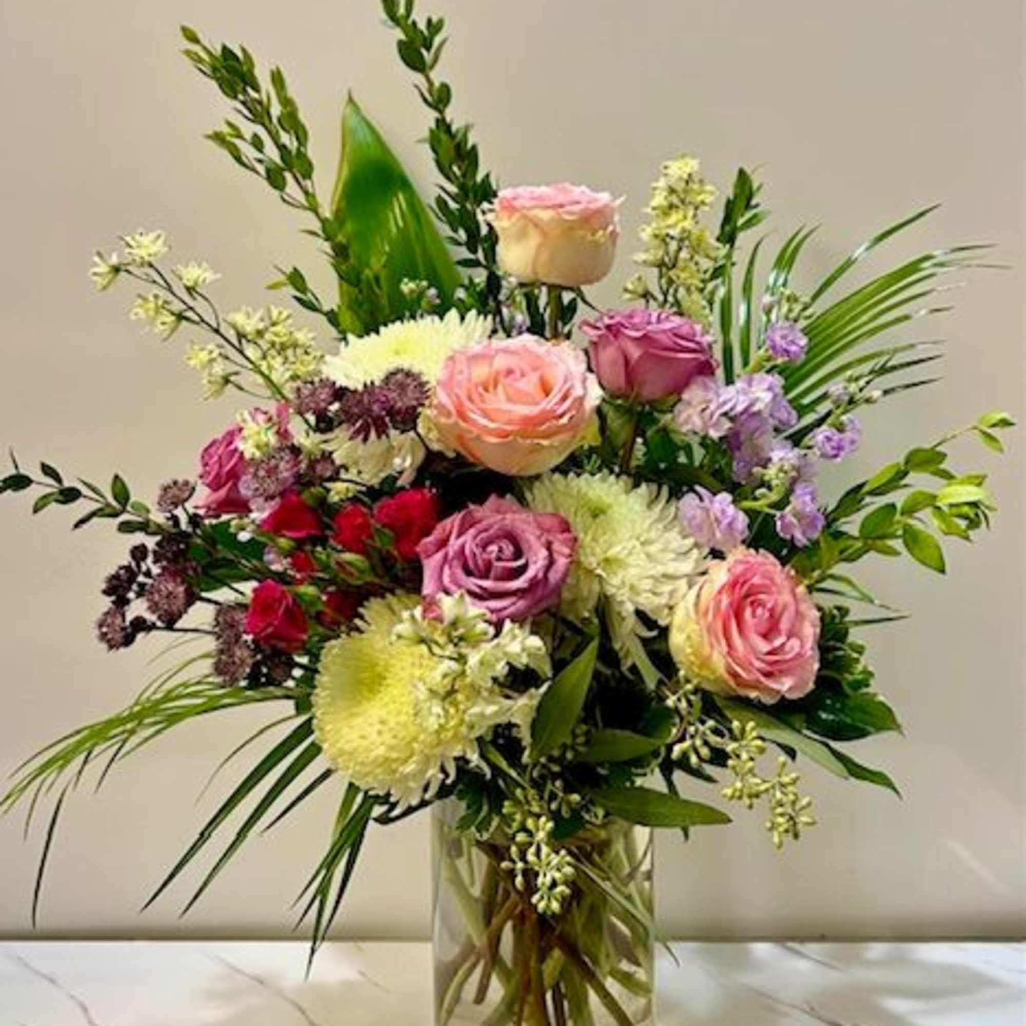 A stunning floral arrangement in a tall vase, offering a serene and