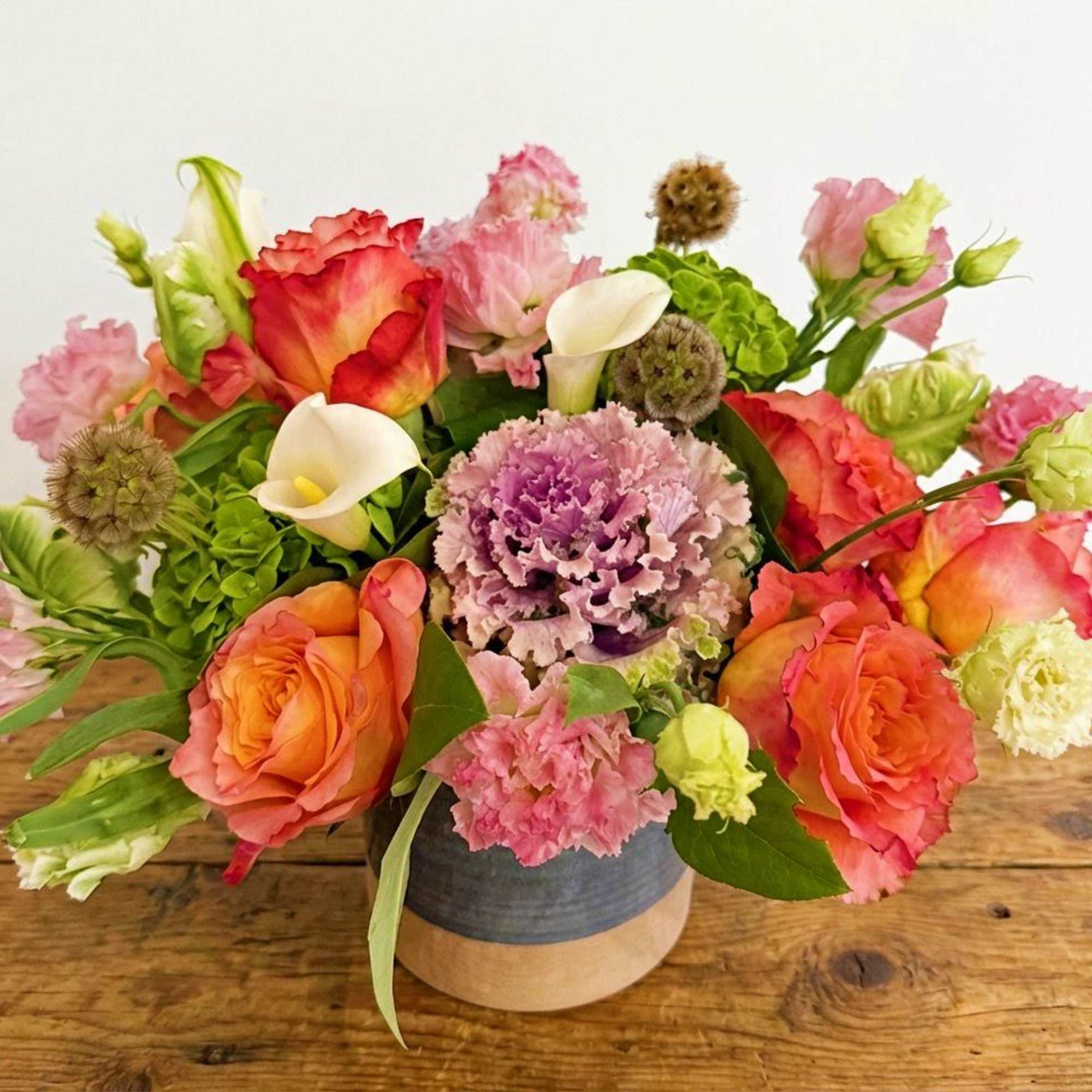 This arrangement is presented in a 5" cylinder vases. It features orange