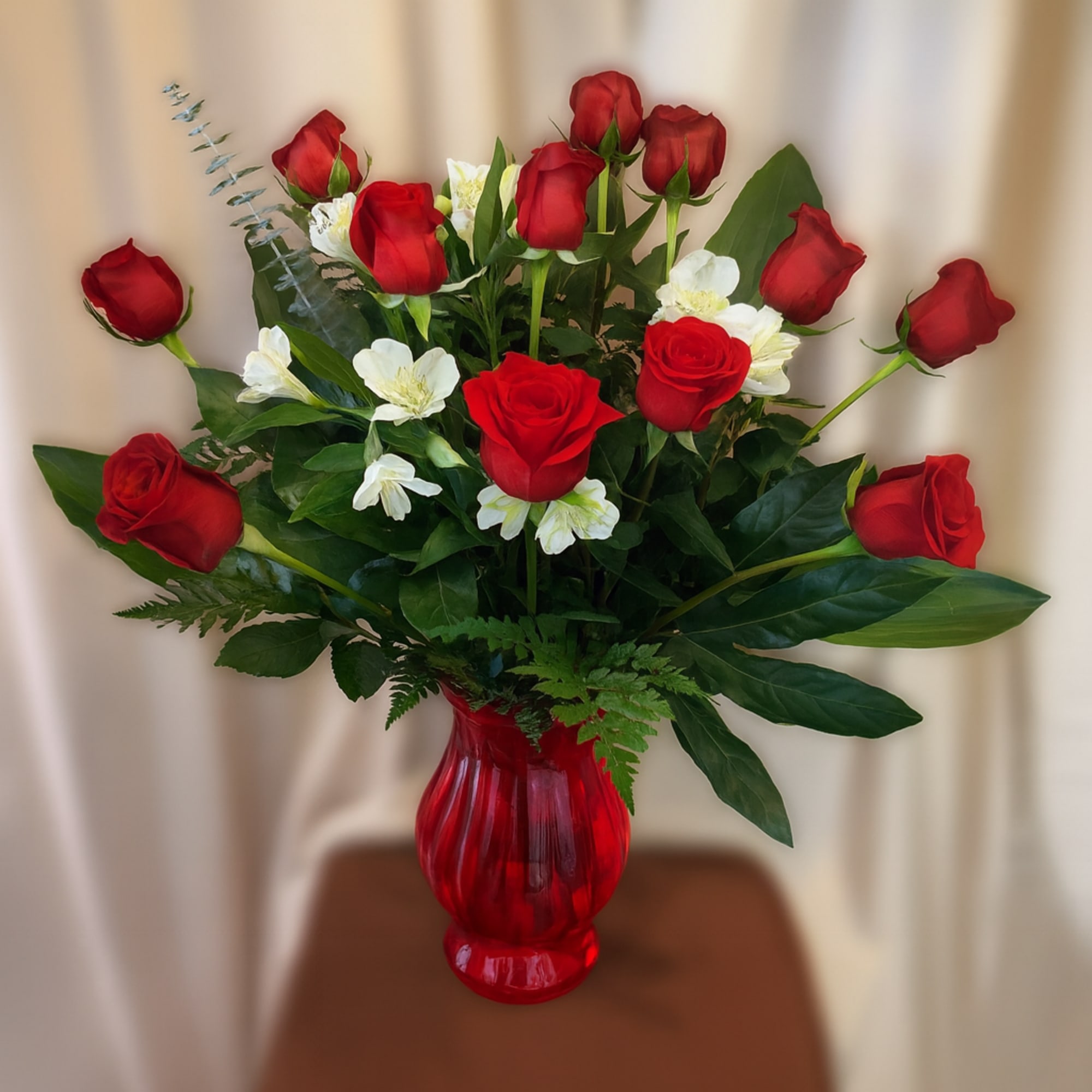 Our Signature Dozen Elegant Red Roses in a festive Red vase for