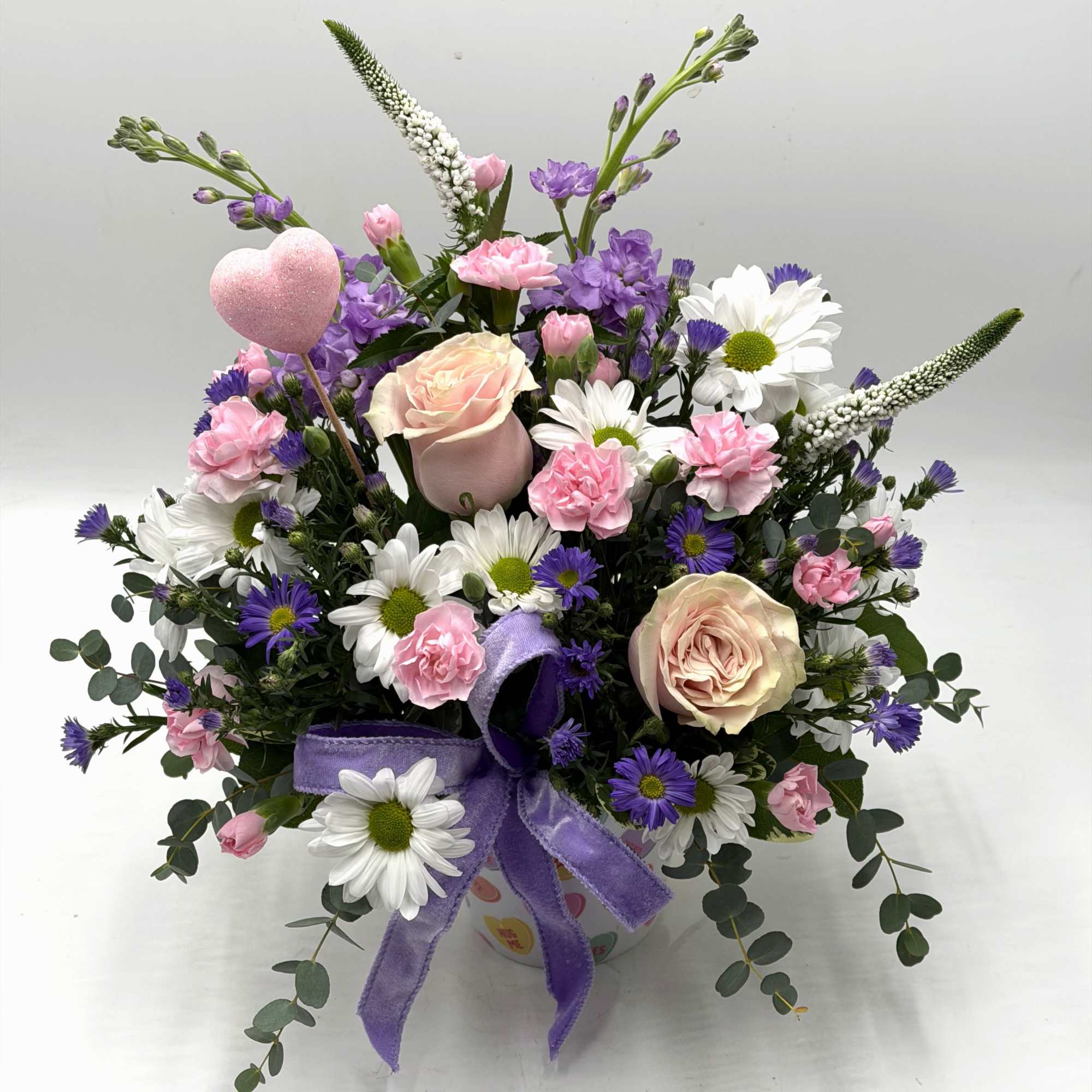 Celebrate love with soft blush roses, sweet pink carnations, white daisies and