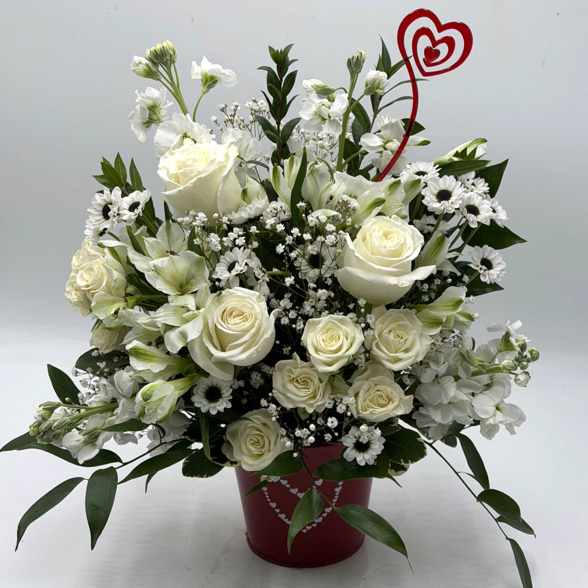 A graceful Valentine's Day arrangement of creamy white roses, white spray roses