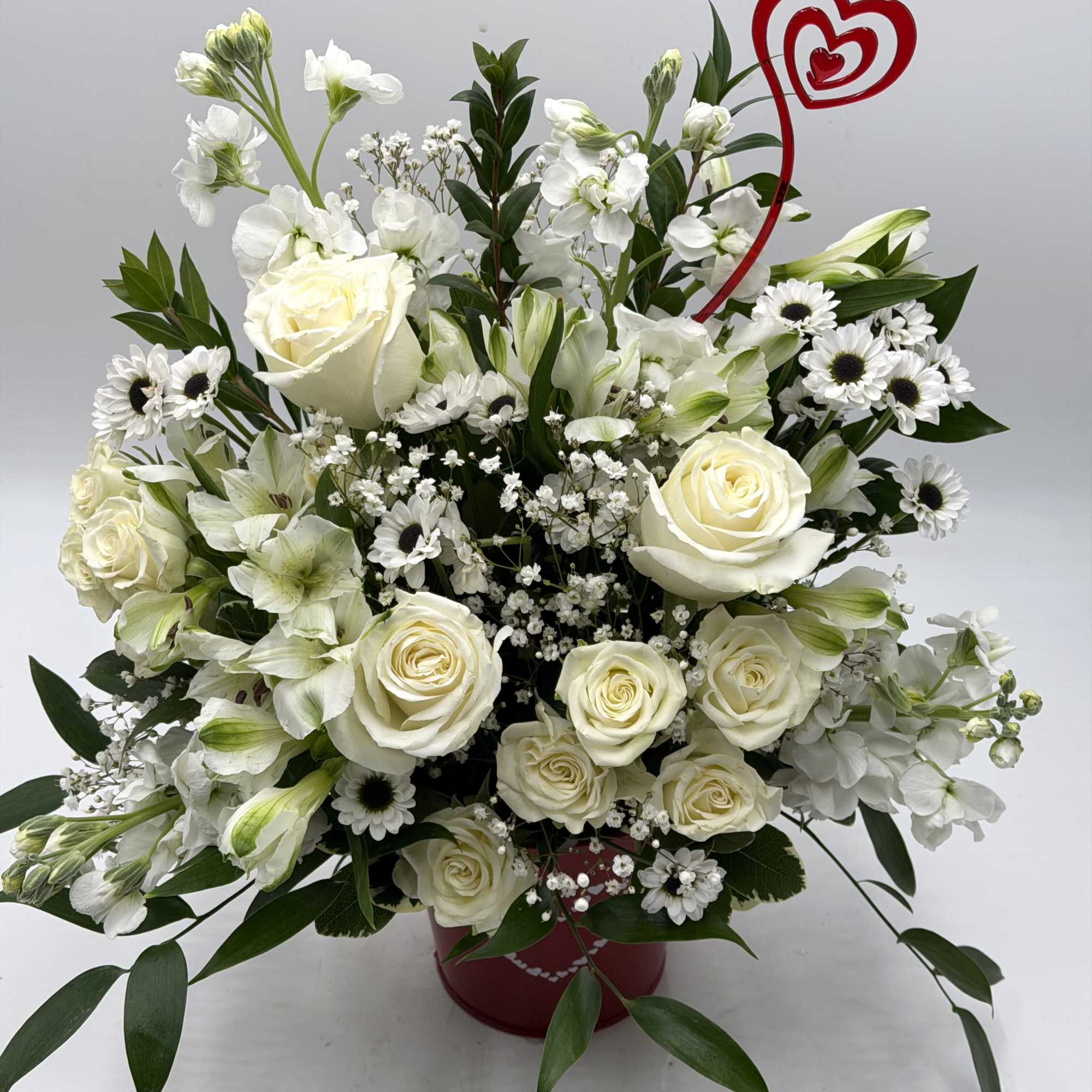A graceful Valentine's Day arrangement of creamy white roses, white spray roses