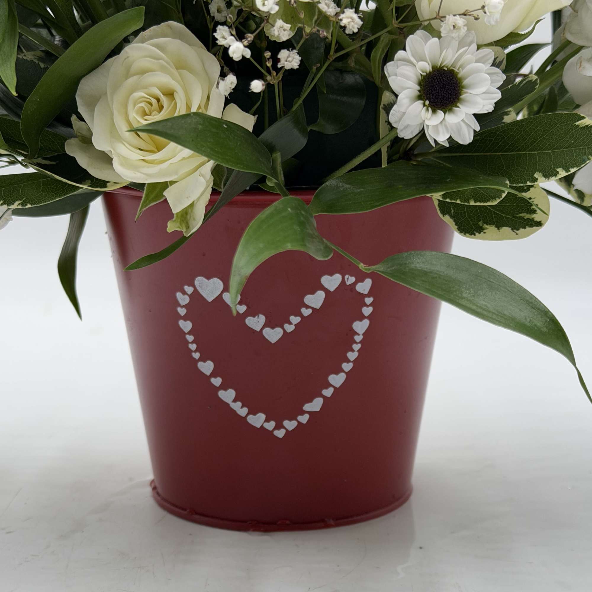 A graceful Valentine's Day arrangement of creamy white roses, white spray roses