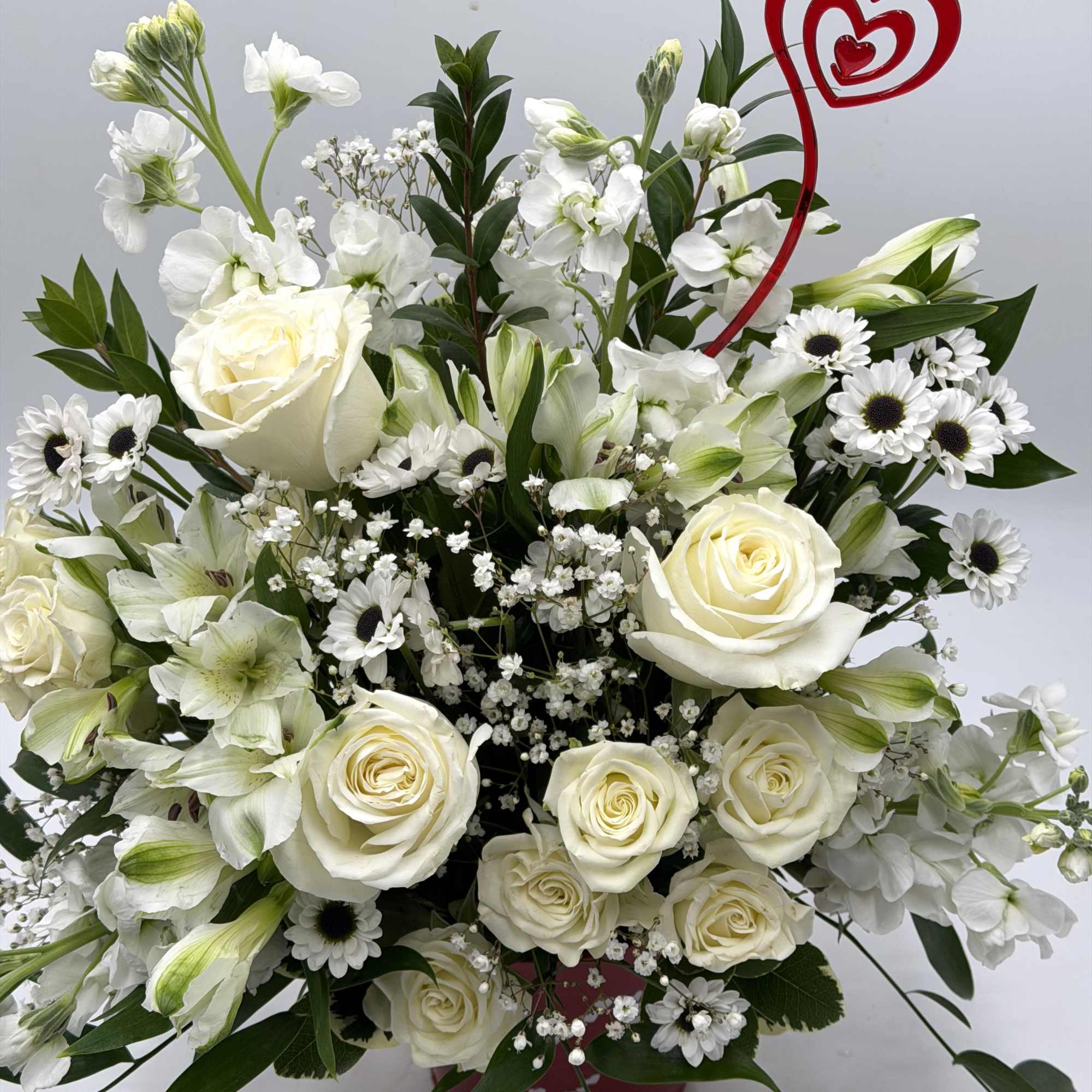 A graceful Valentine's Day arrangement of creamy white roses, white spray roses