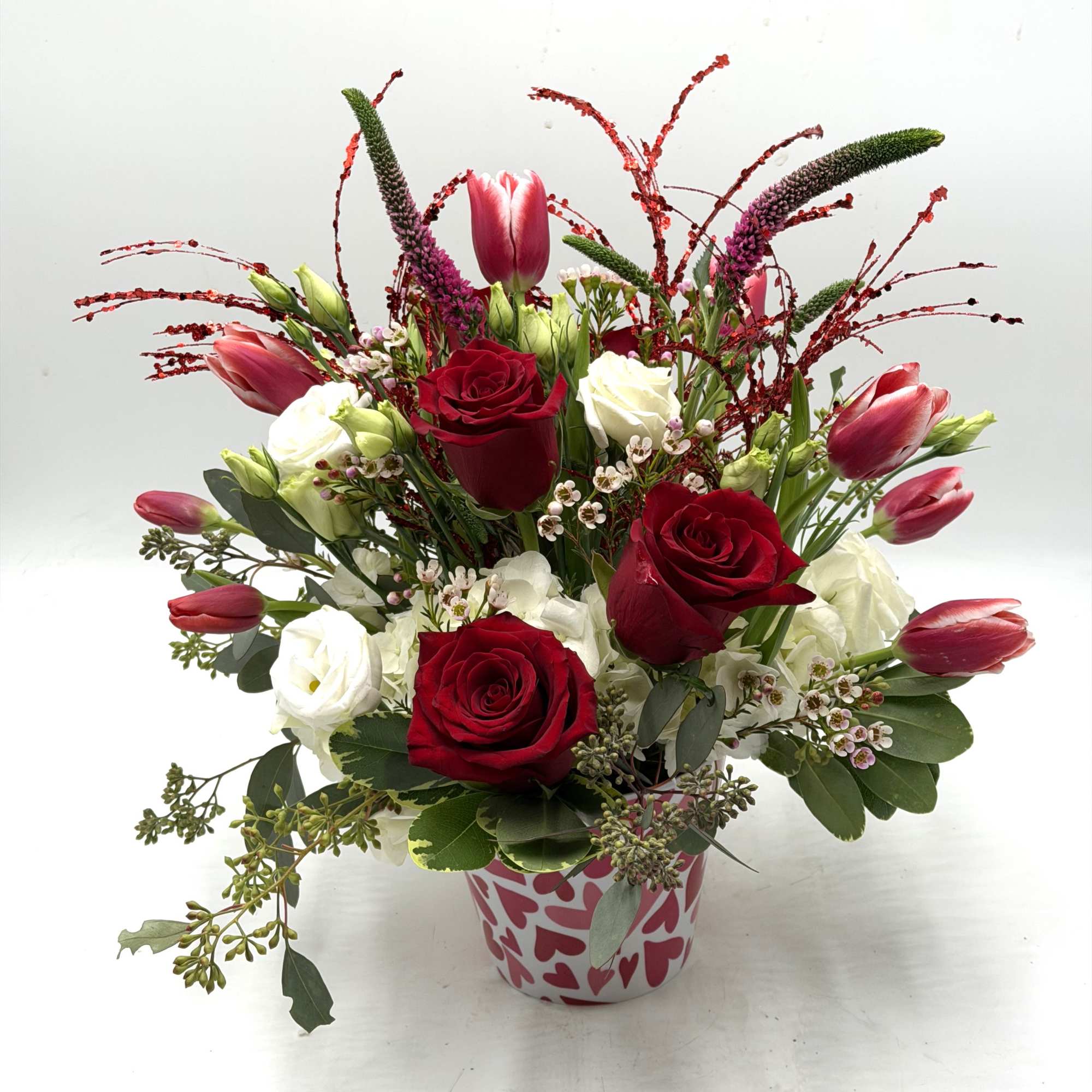 A contemporary take on Valentine's florals, this arrangement features vibrant red roses