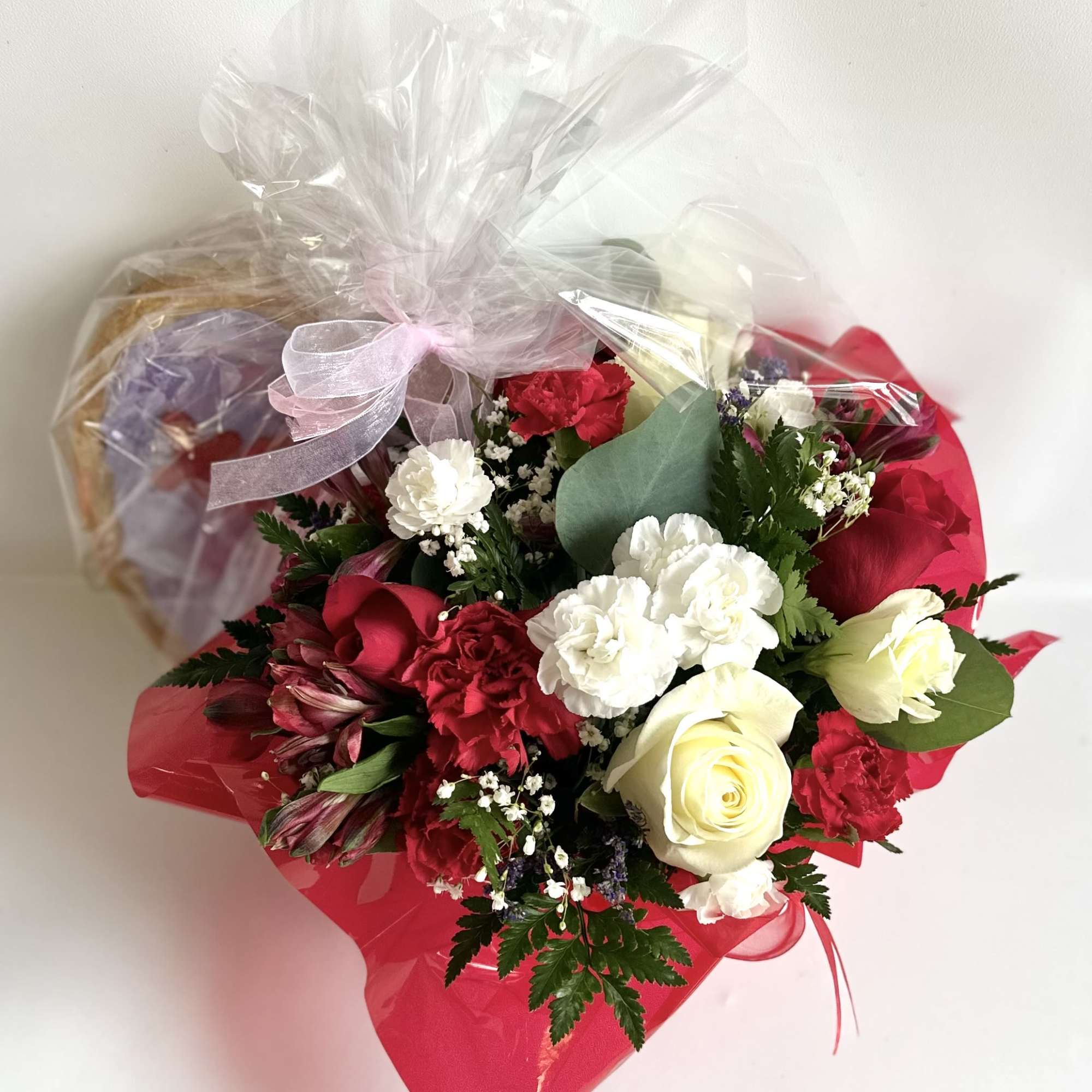 This cute basket bouquet wrapped in red cello is a perfect to