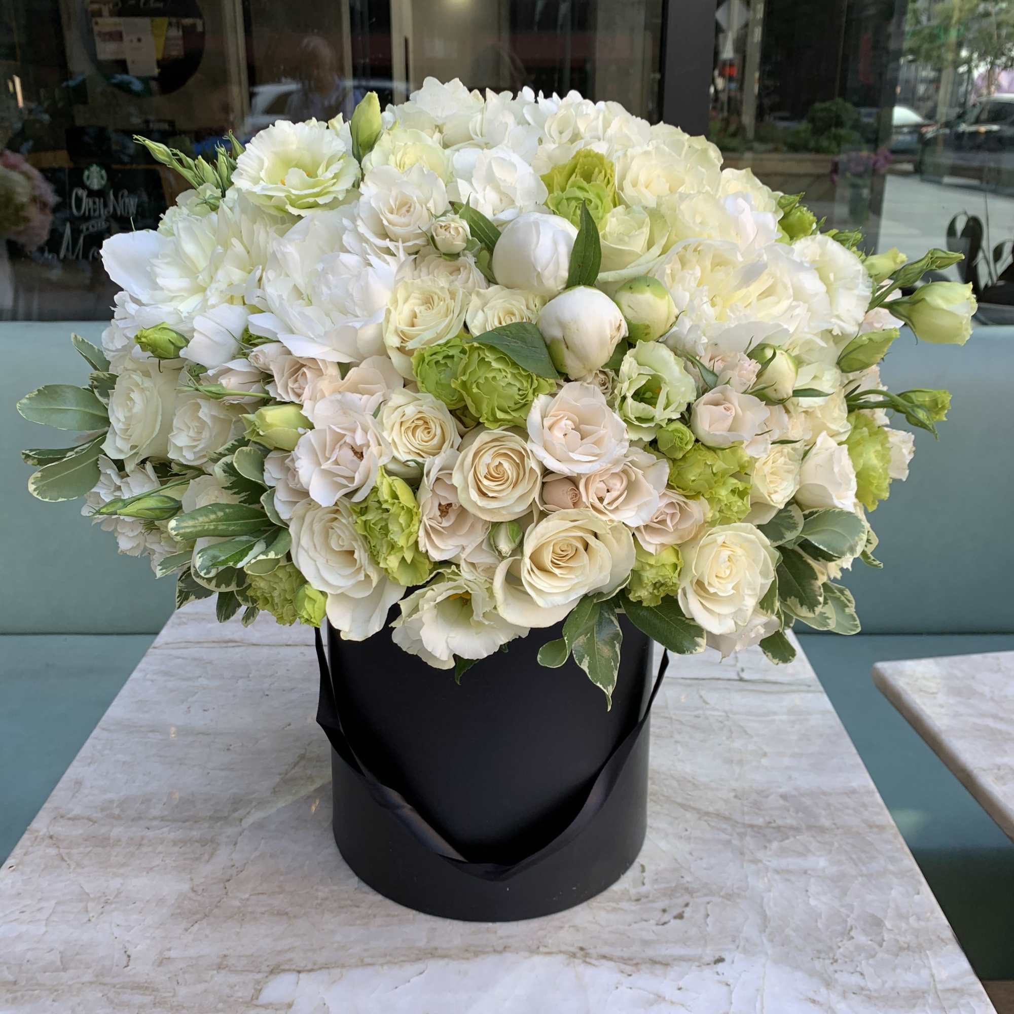 Stunning white and green flower arraignment in a black velvet box