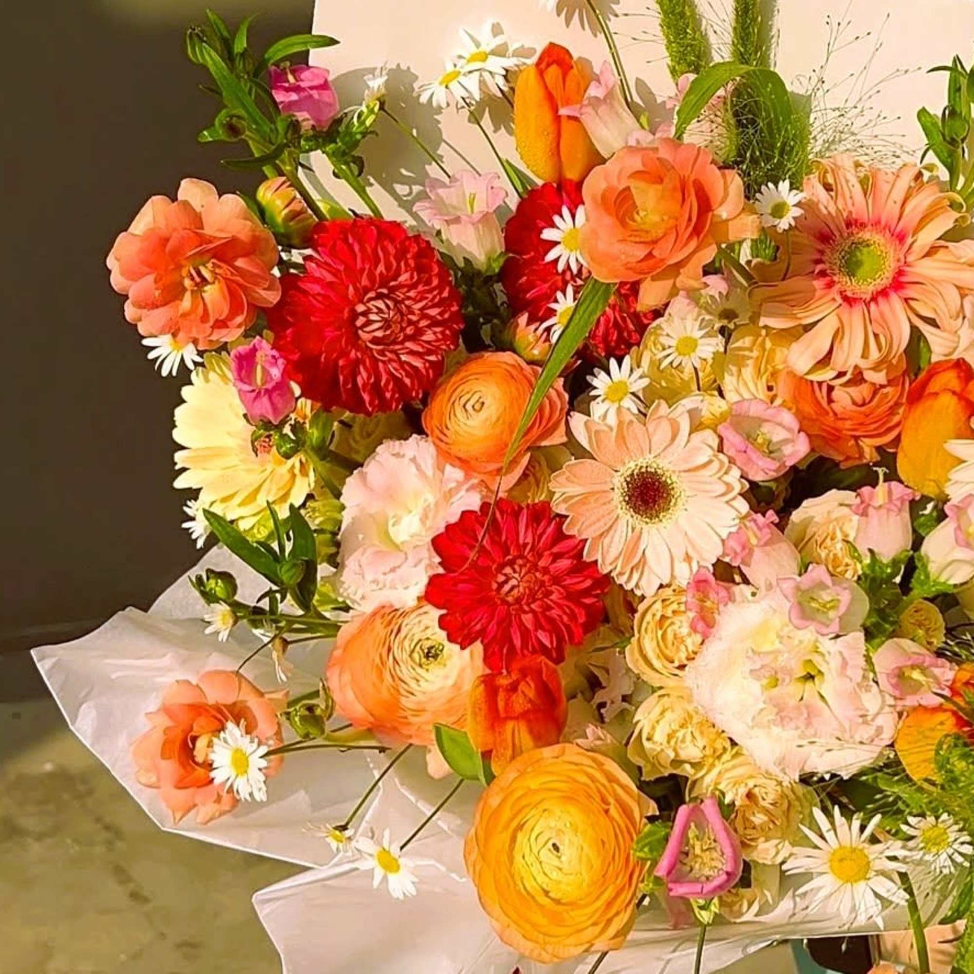 Custom mixed bouquets are wrapped in kraft paper or color plastic paper