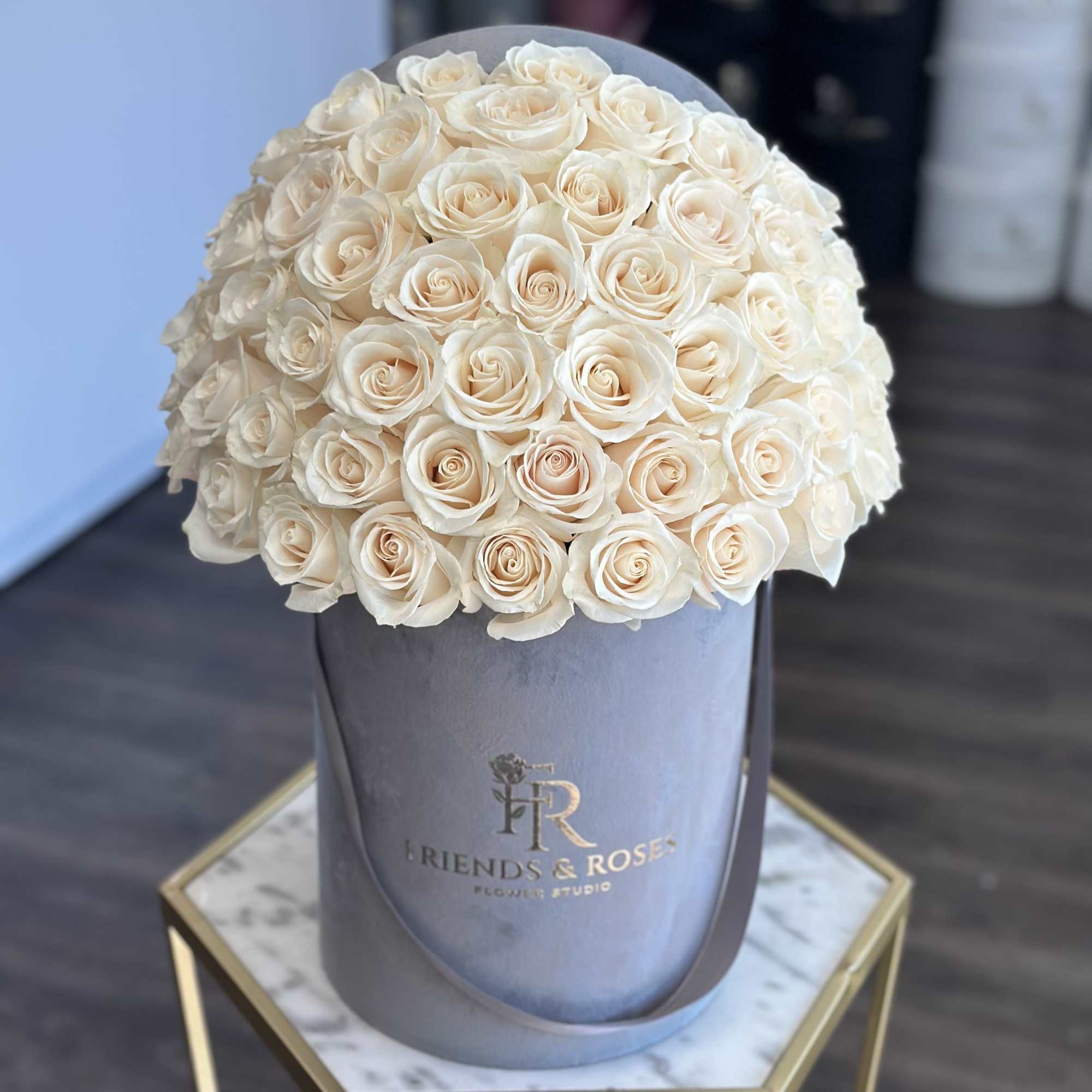 Our signature gray box, filled with 50 fresh-cut white roses, is a