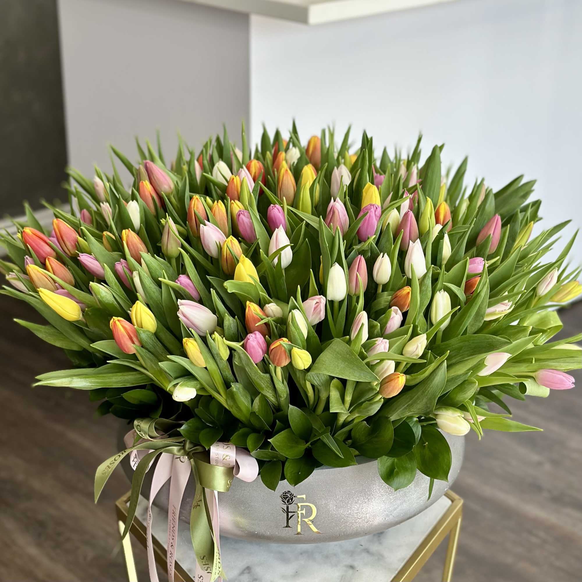 A stunning composition of tulips in a sleek, modern vase, their petals