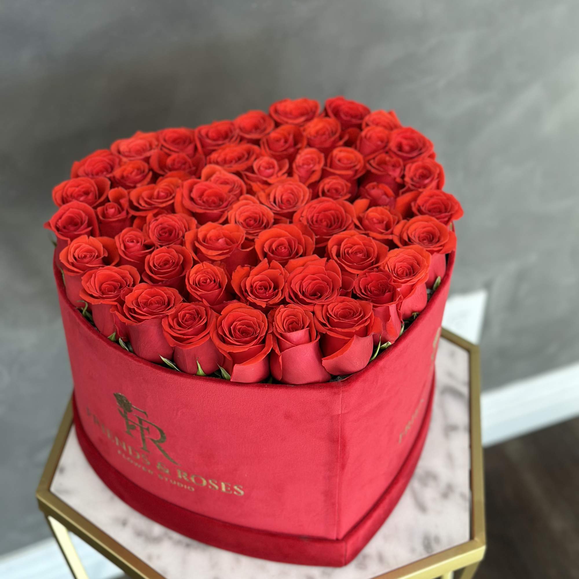 A beautiful arrangement in our heart signature box with fresh roses in