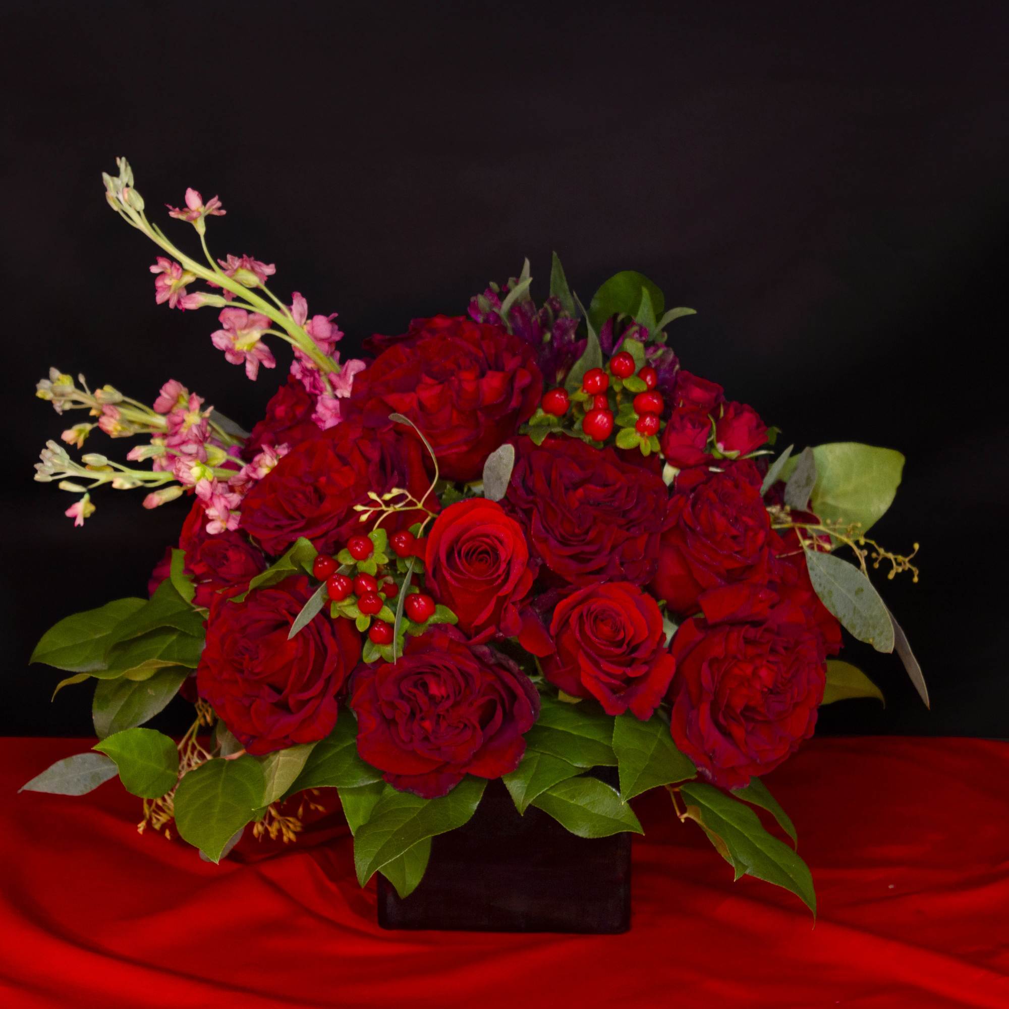 Fiery, passionate reds explode from lush glossy greens, and accents of seeded