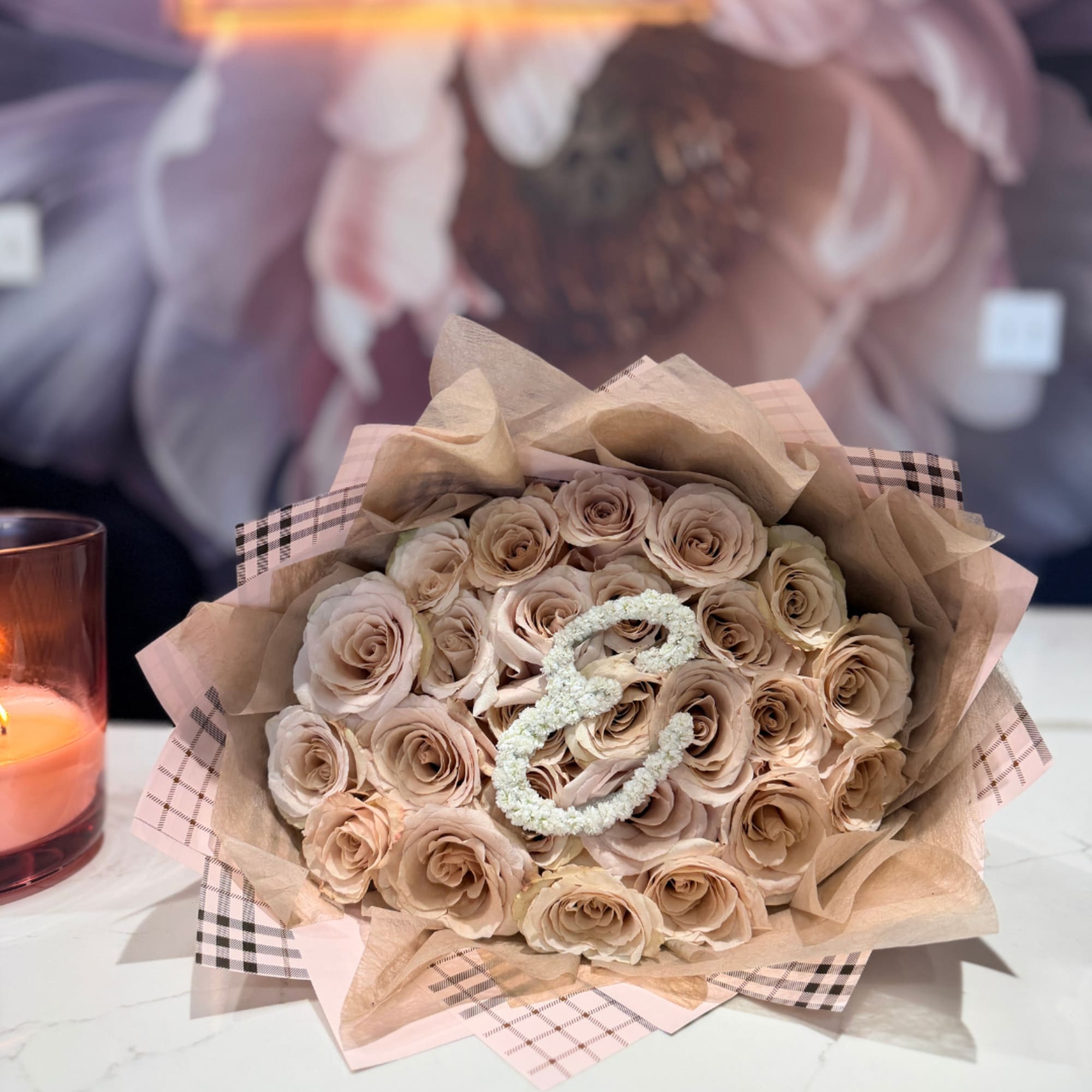 Featuring creamy roses, this bouquet is wrapped in distinctive Burberry-inspired plaid print