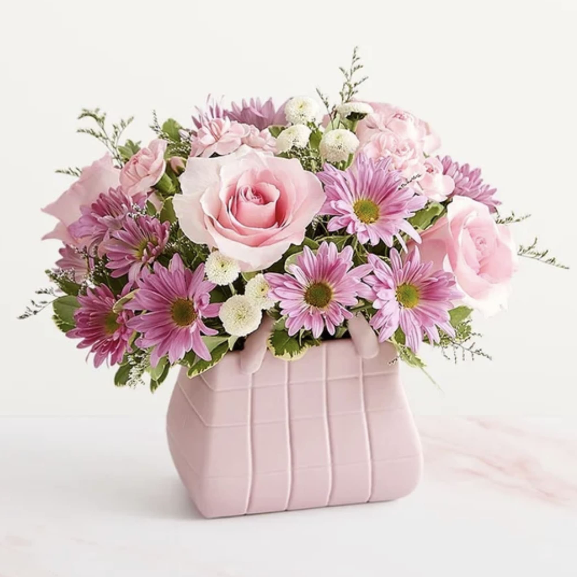 The ultimate arrangement for your favorite fashionista. A profusion of roses, poms