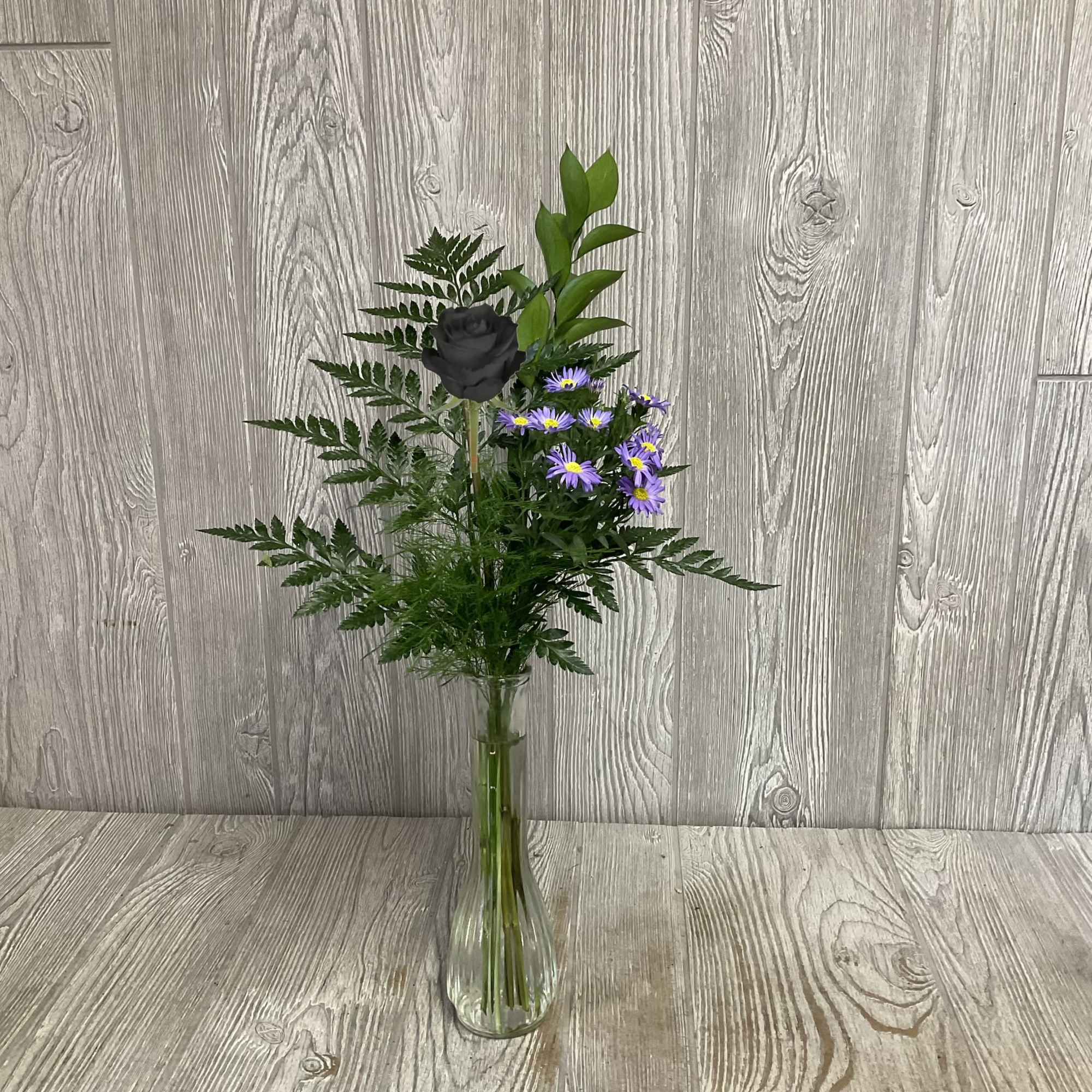 Special available Valentine&rsquo;s week. An enhanced black rose in a bud vase.