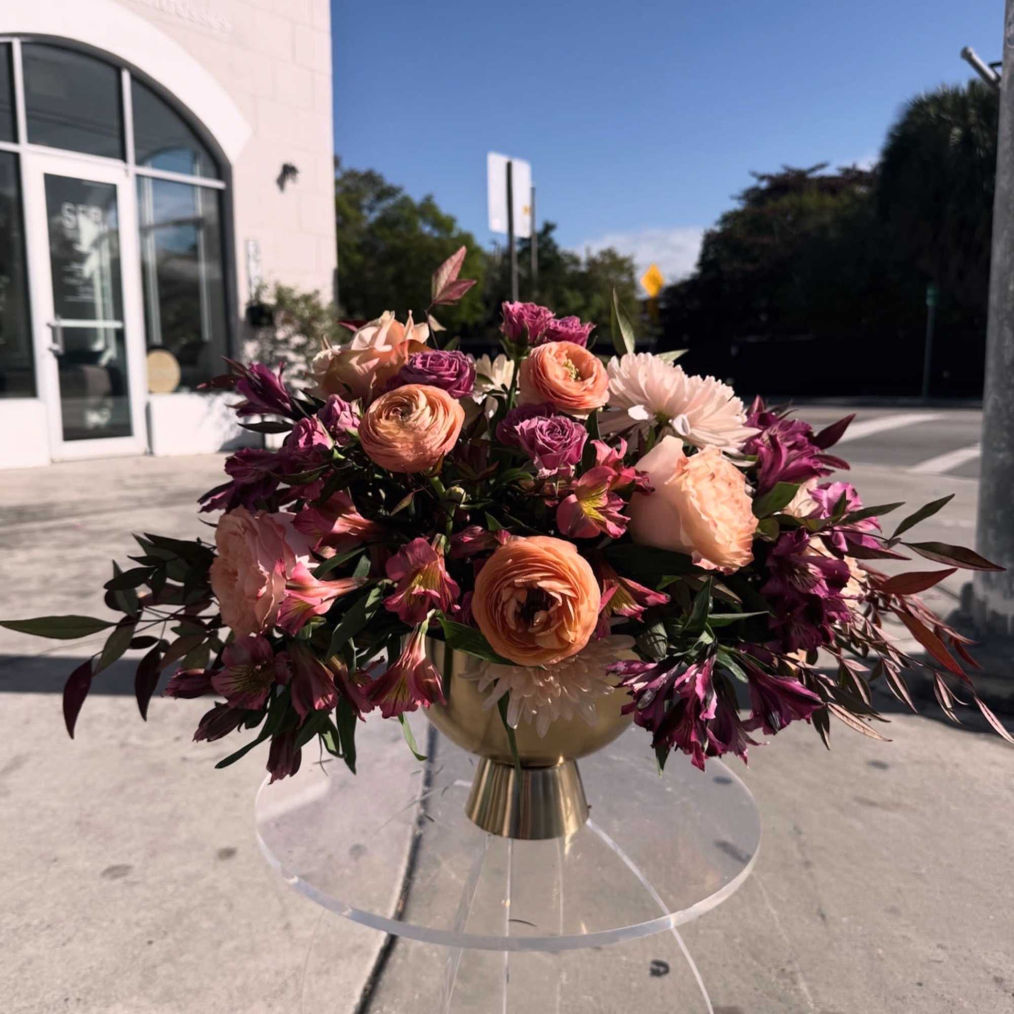 Peach roses and blush florals meet deep magenta accents in this lush