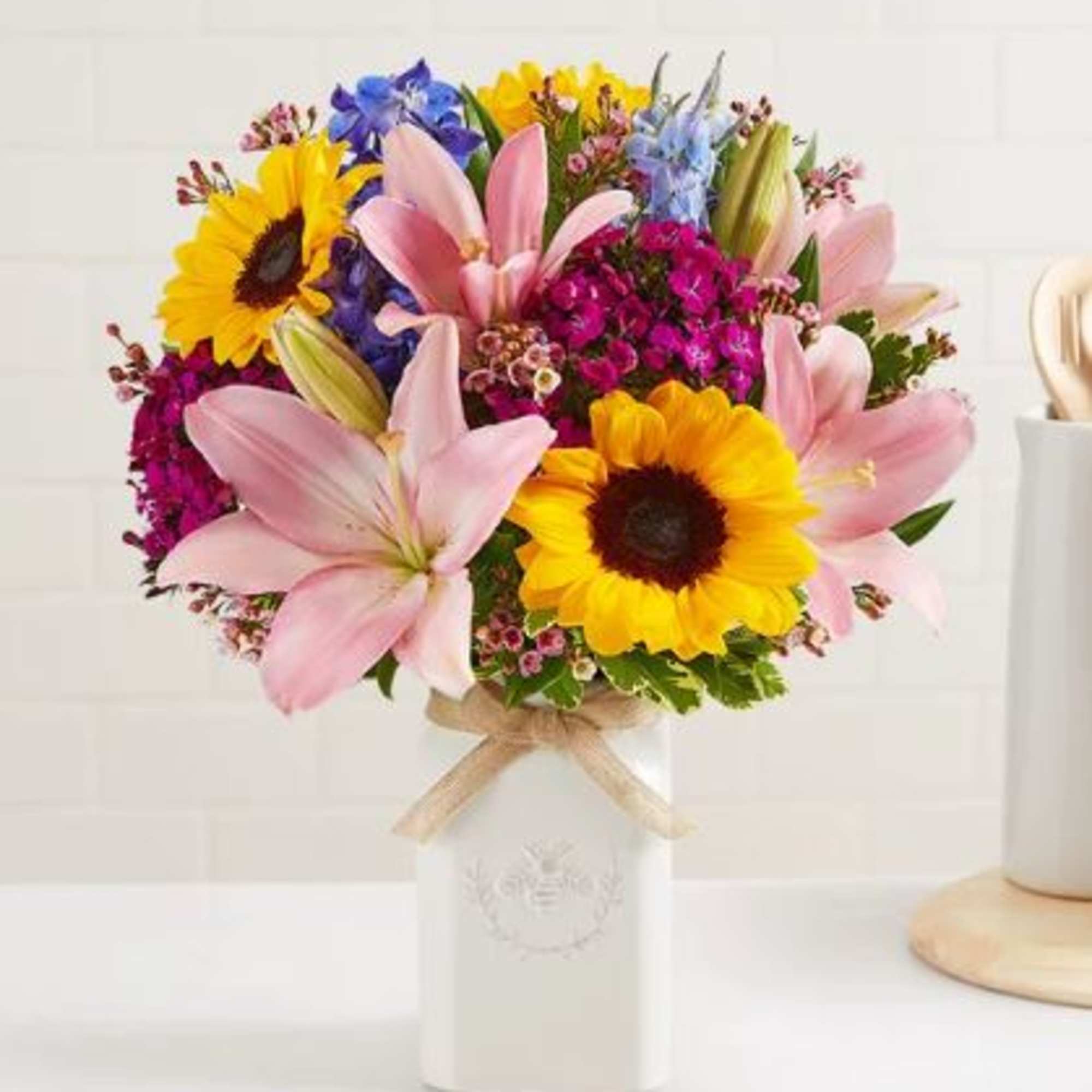 Get them buzzing with our charming bouquet! Sunflowers, Pink Asiatic Lily, Blue