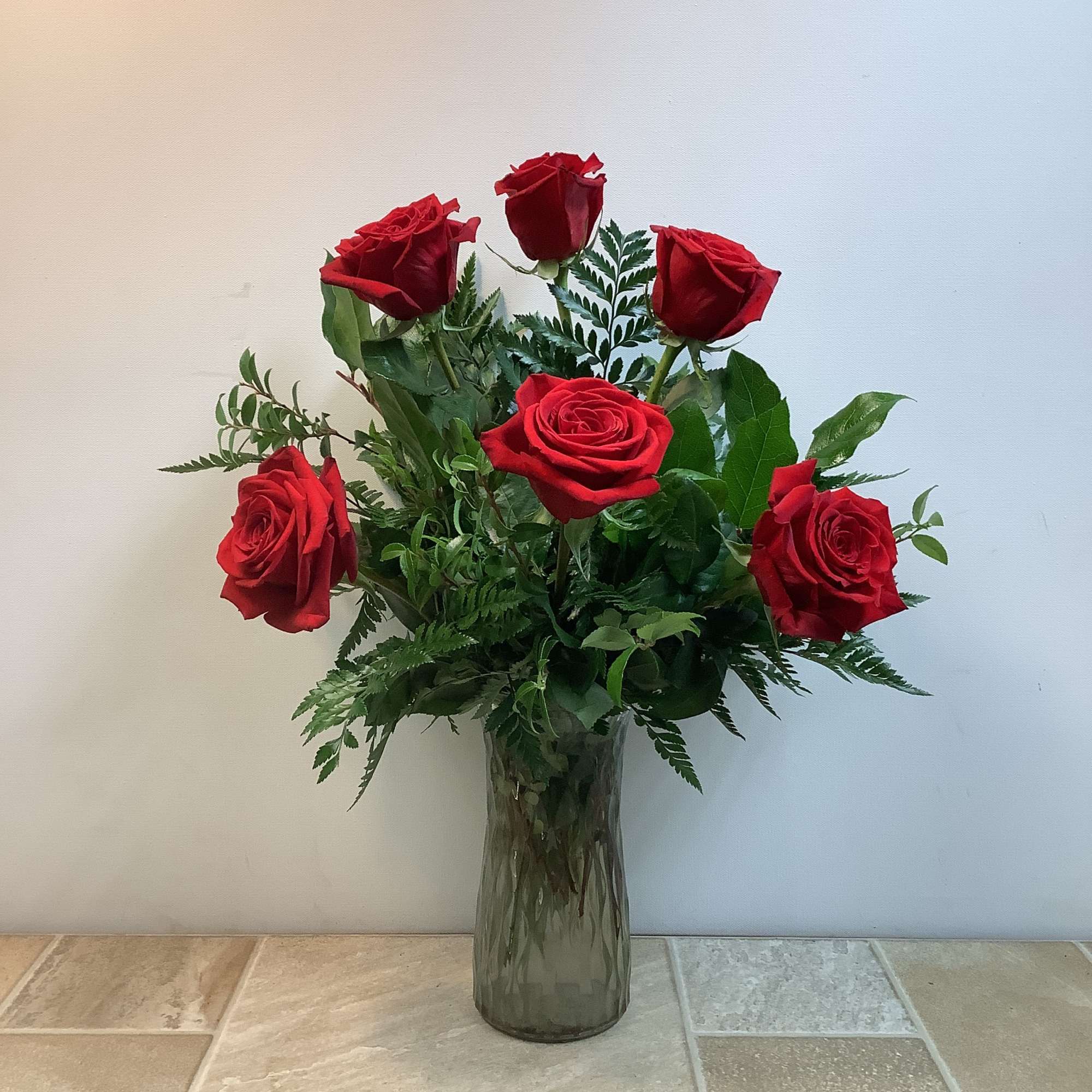 This classic bouquet features a half dozen rich, velvety red roses arranged