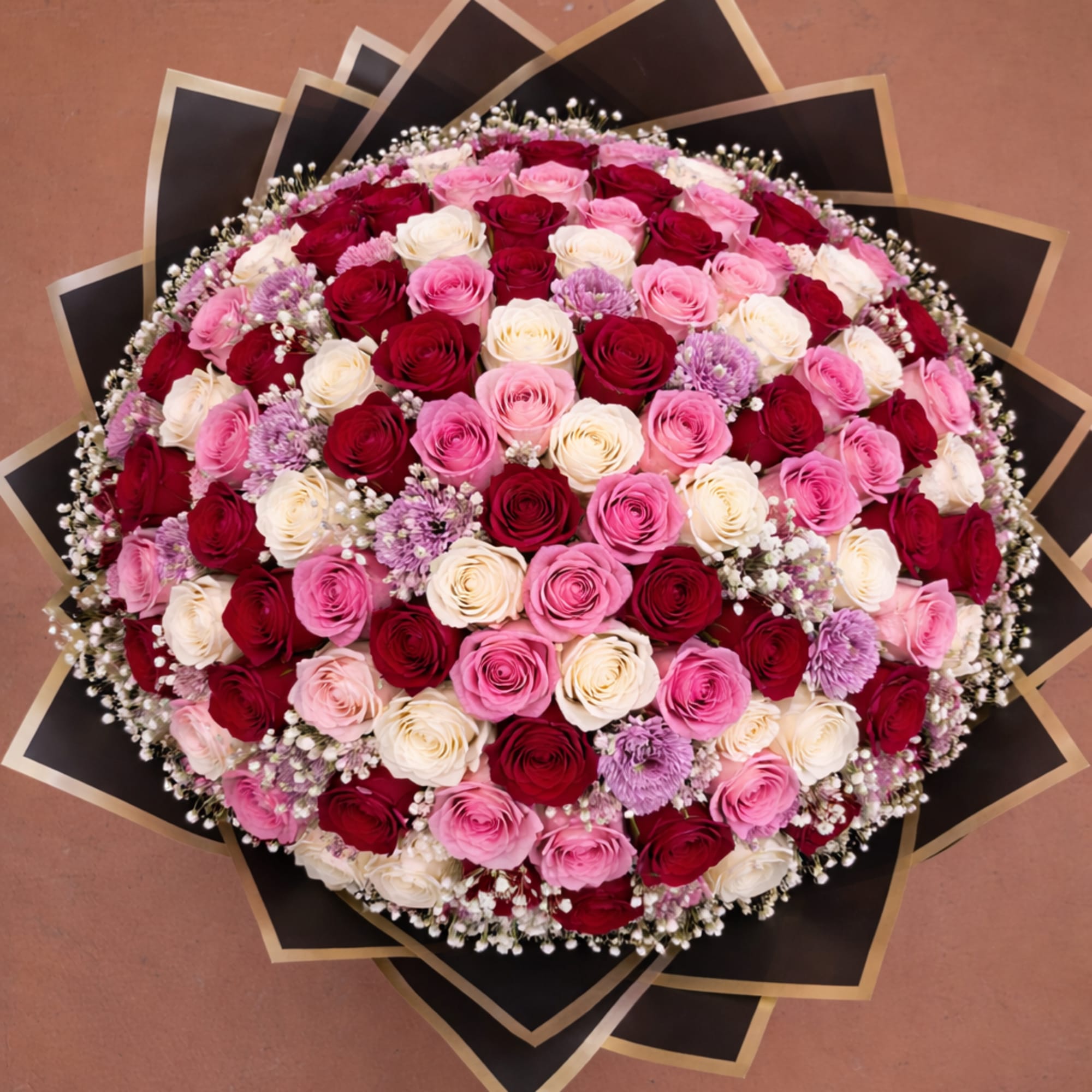This breathtaking bouquet features a luxurious blend of deep red, soft pink