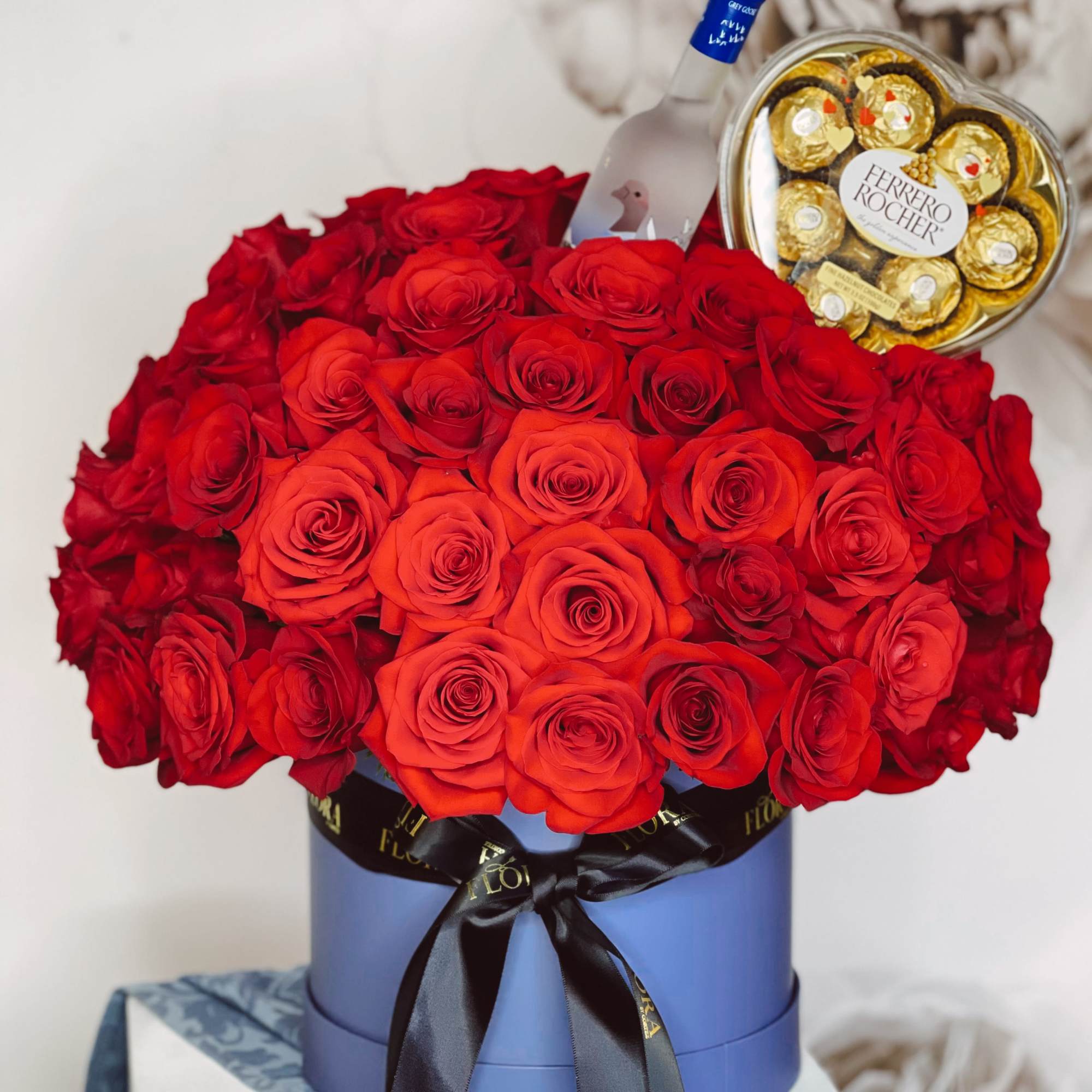 Make a bold statement with 70 red roses, a small Grey Goose