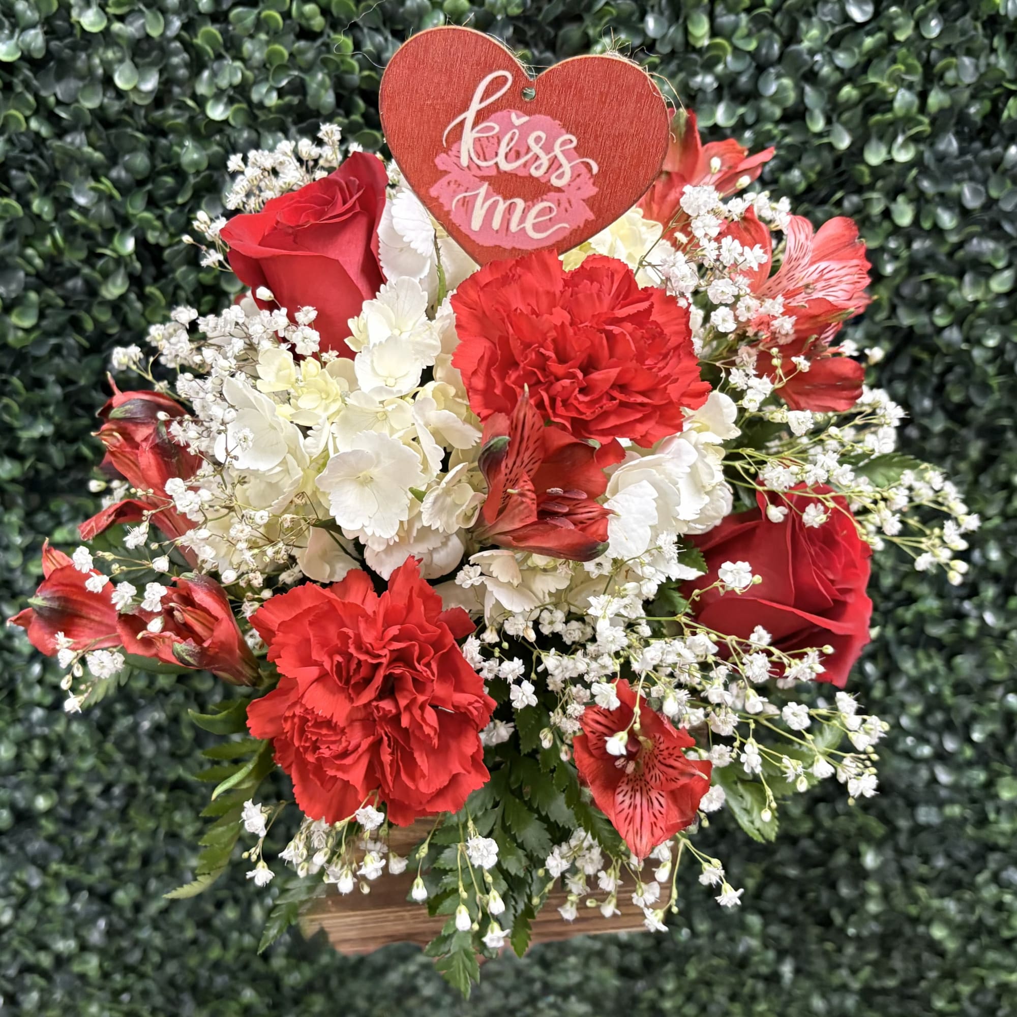 THIS QUAINT WOVEN BASKET IS FILLED WITH MIXED BLOOMS,  ROSES, CARNATIONS