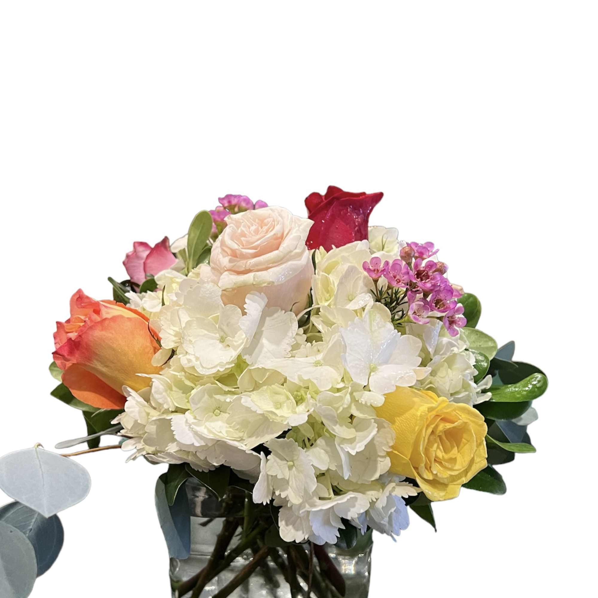 A beautiful arrangement of assorted colorful roses blanketed by white hydrangeas and