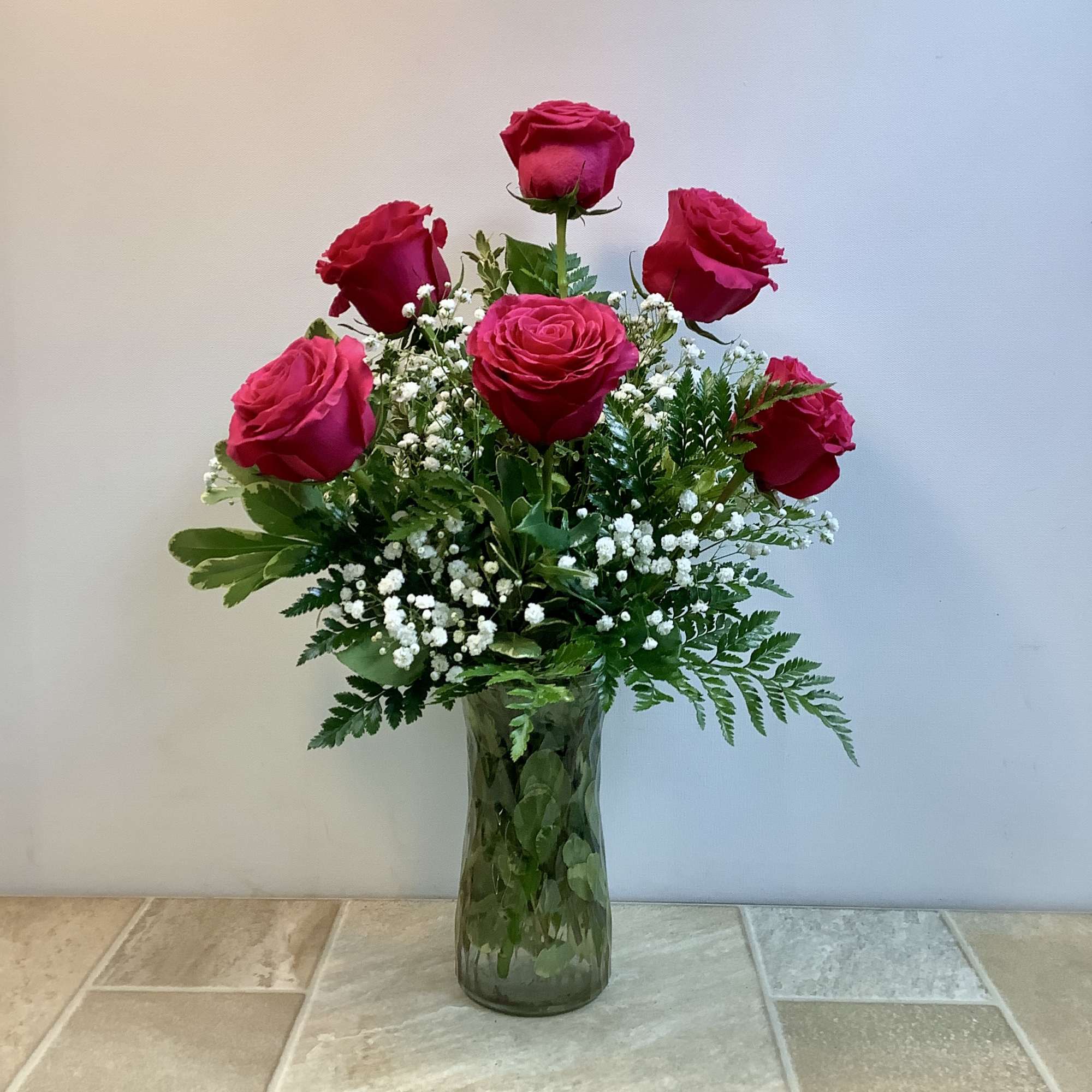 This classic bouquet features six lush pink roses arranged in a tall