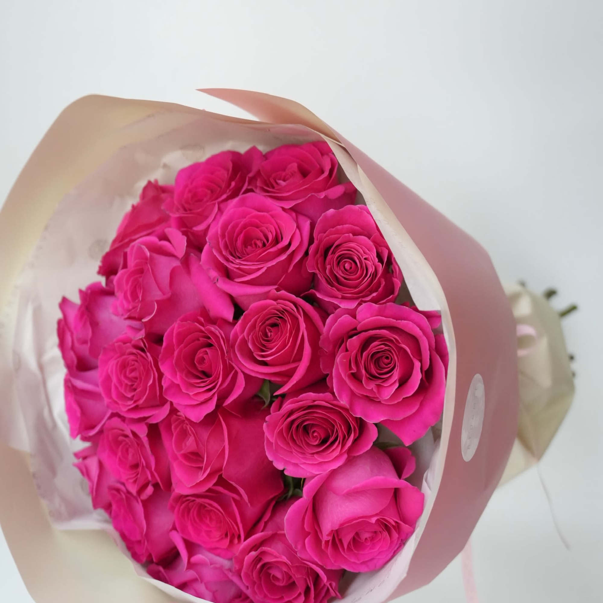 A vibrant bouquet of hot pink roses bursts with energy and passion.
