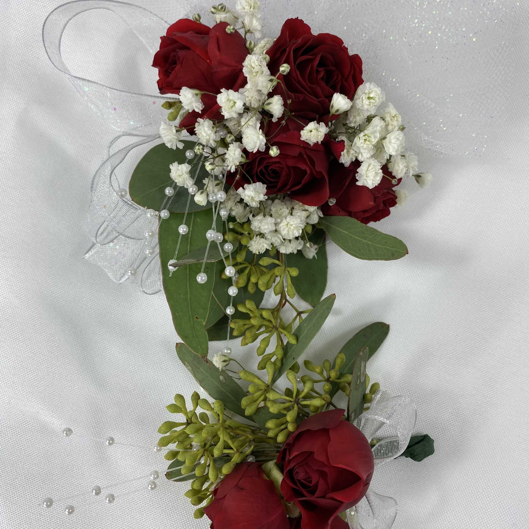 Red roses and babies breath with white ribbons. 

