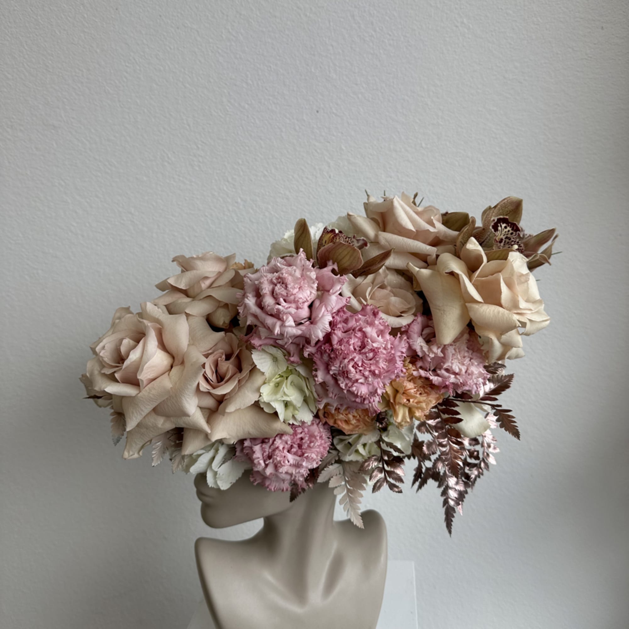 This beautiful arrangement is filled with beige roses, hydrangeas and greens to