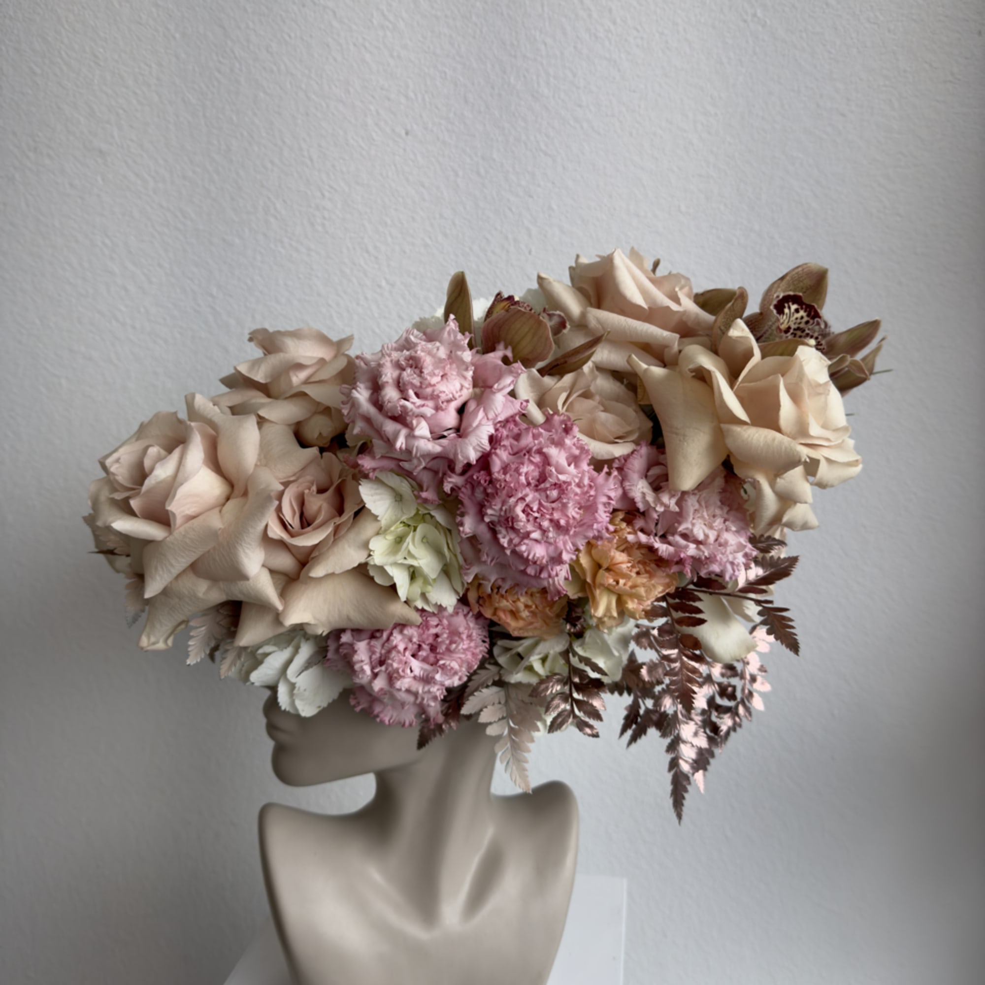 This beautiful arrangement is filled with beige roses, hydrangeas and greens to