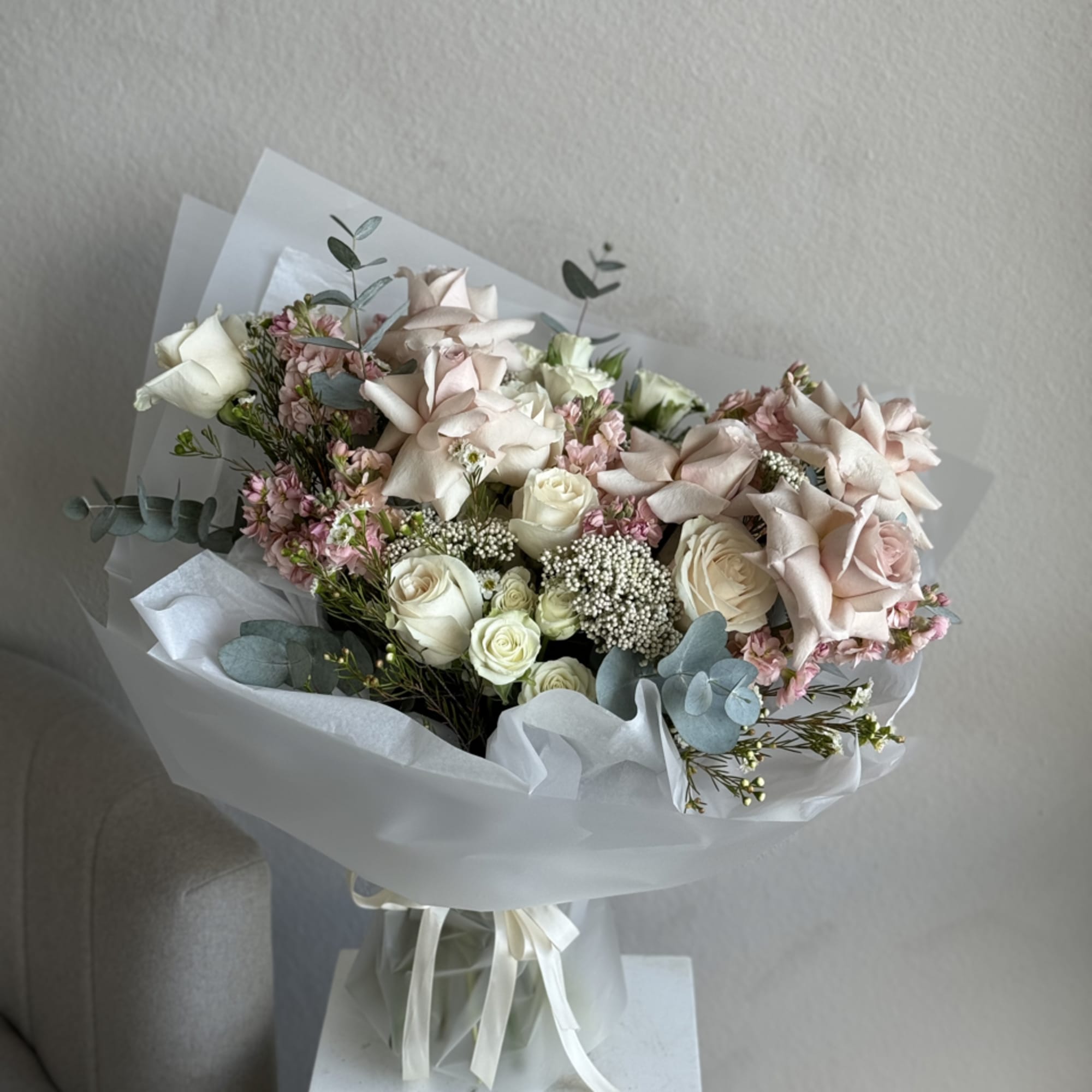The Charm Bouquet is a delightful handheld arrangement featuring an array of