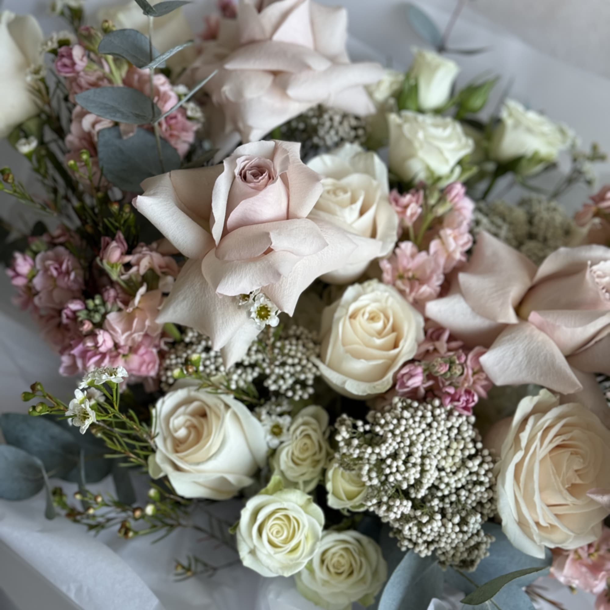 The Charm Bouquet is a delightful handheld arrangement featuring an array of