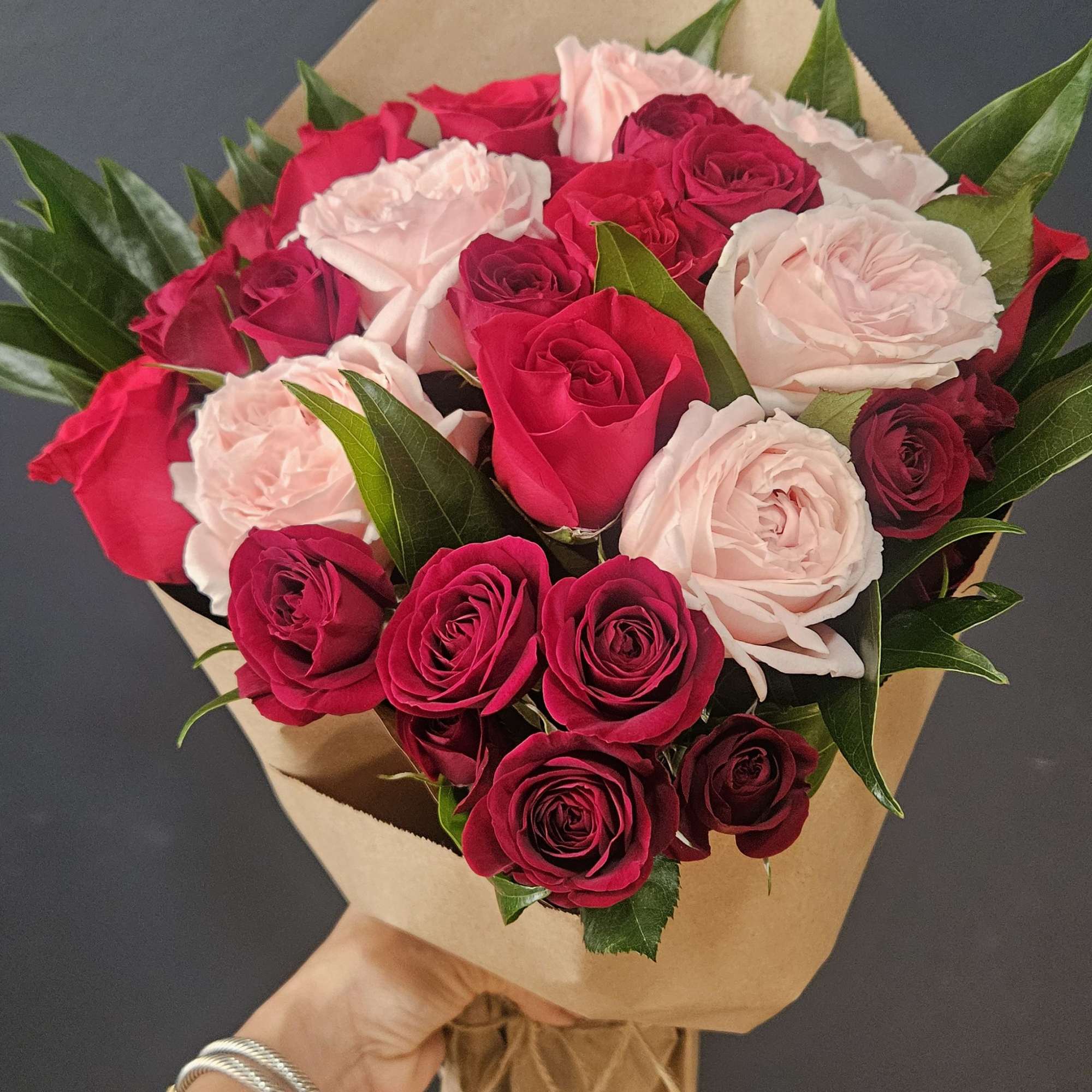 A beautiful wrapped arrangement 
Of six red roses, six fragrant garden pink