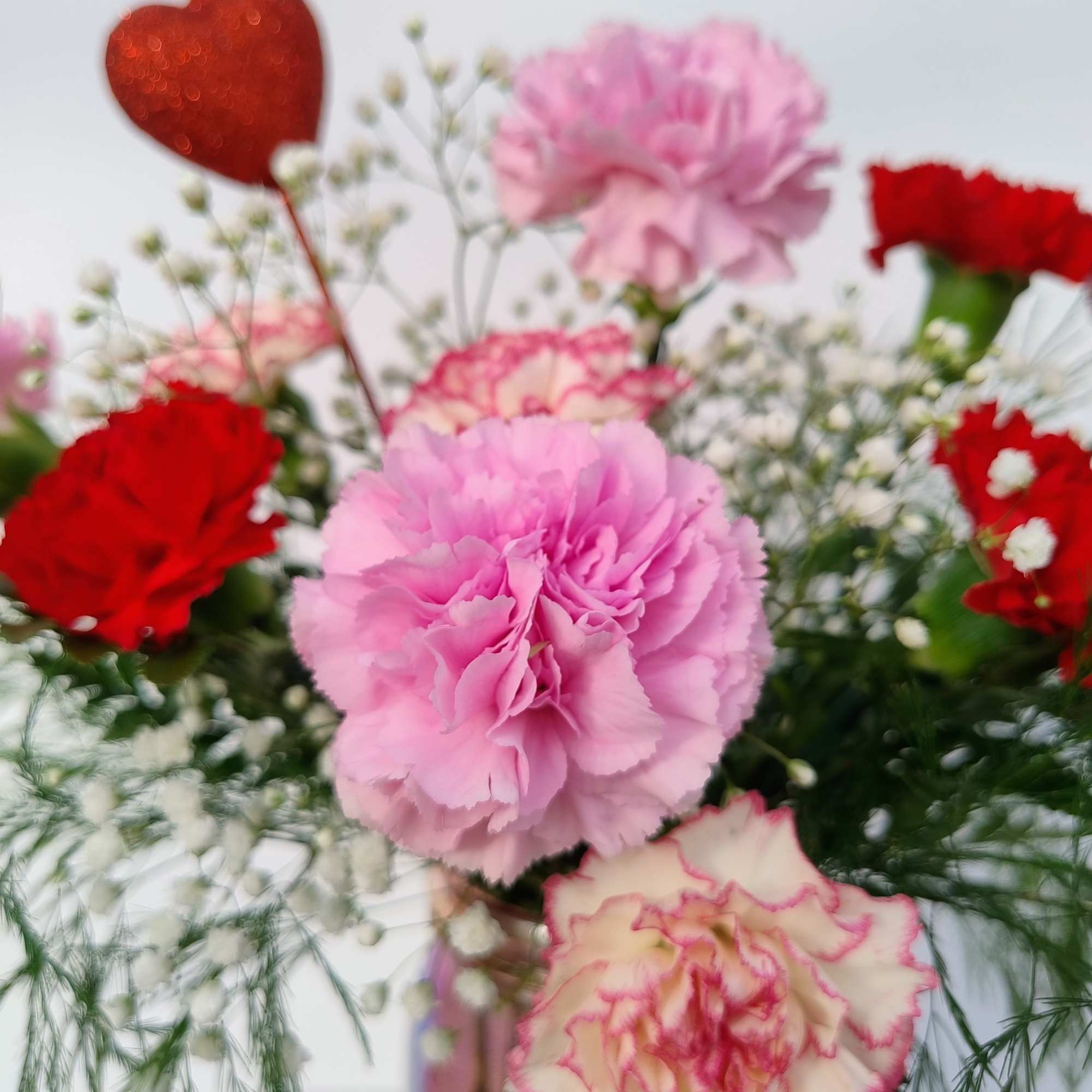 This keepsake iridescent pink mason jar with an embossed heart is filled