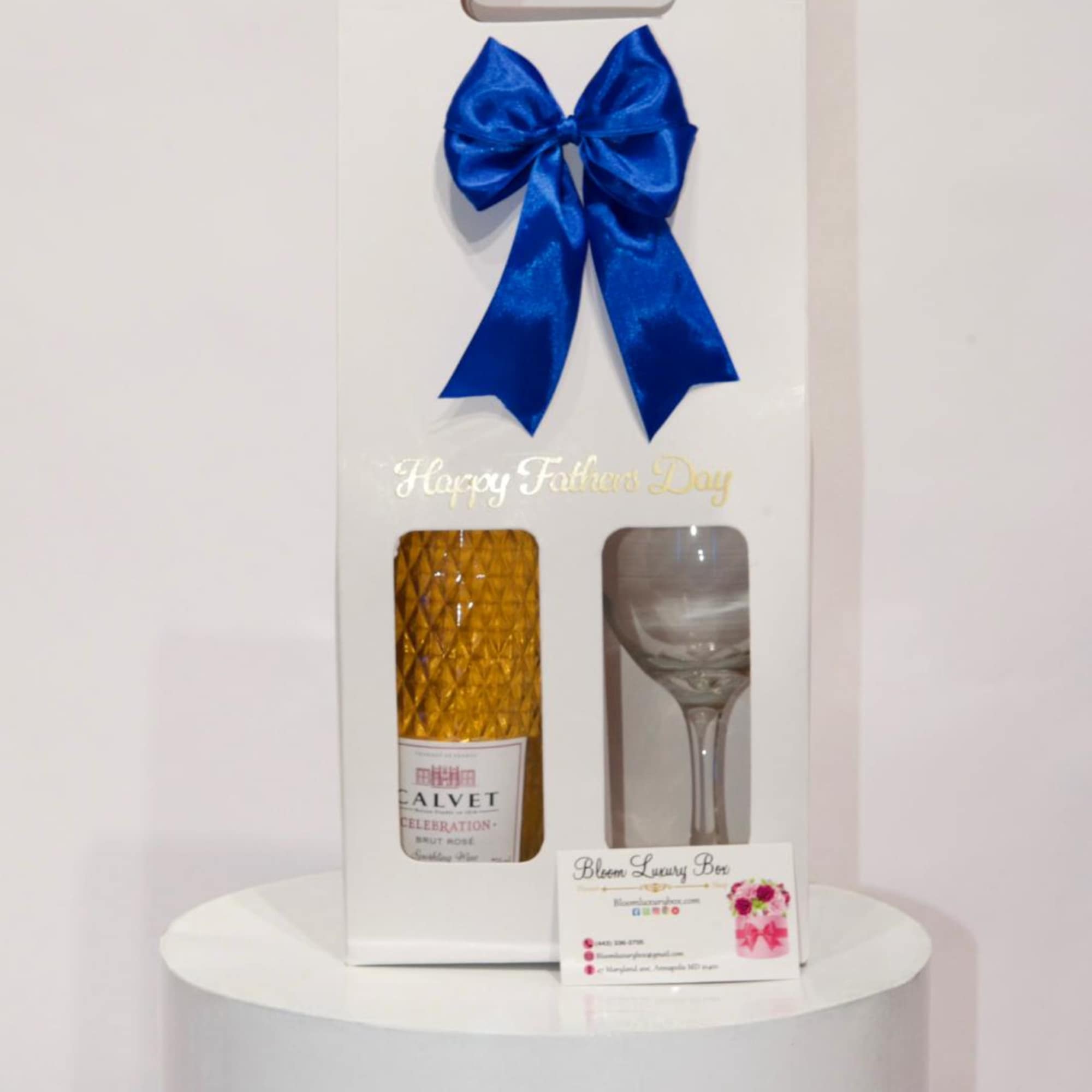 white gift bag with wine bottle and a wine glass. with a