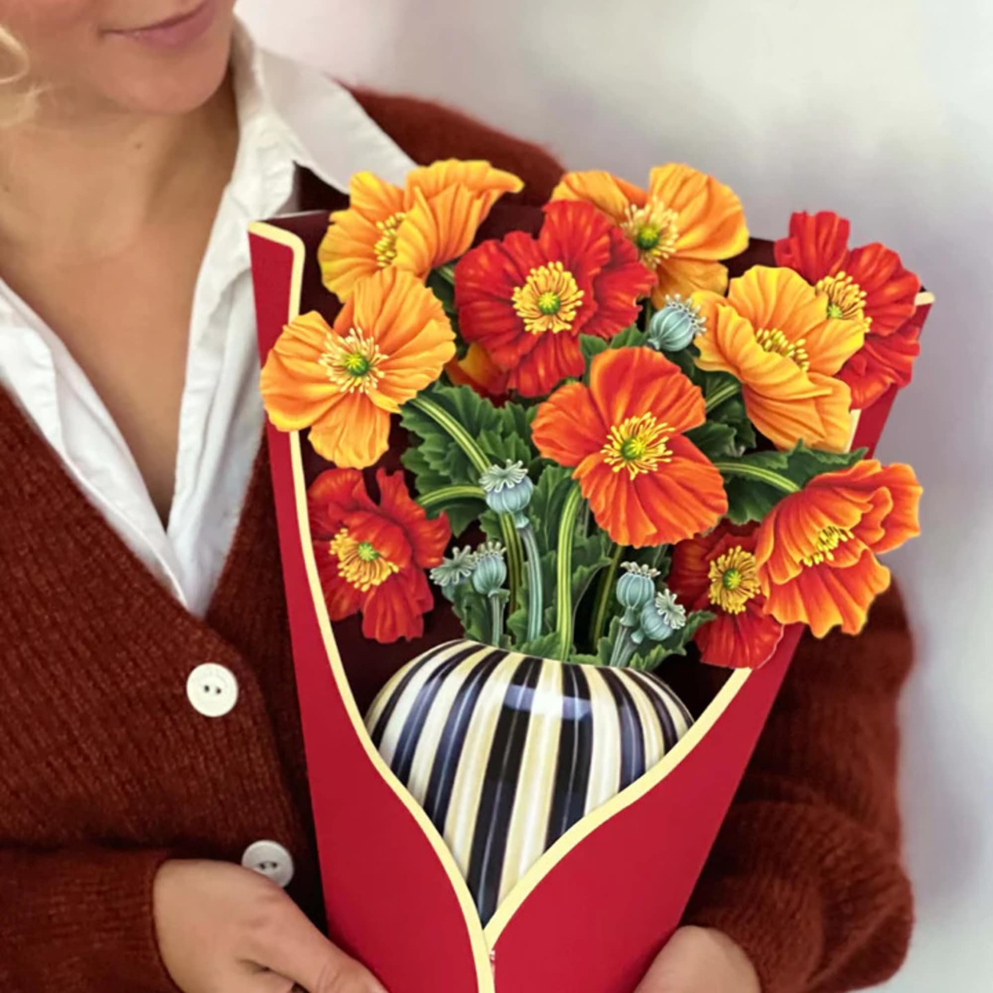 Stunning paper floral bouquet pops open and brings color to any room.