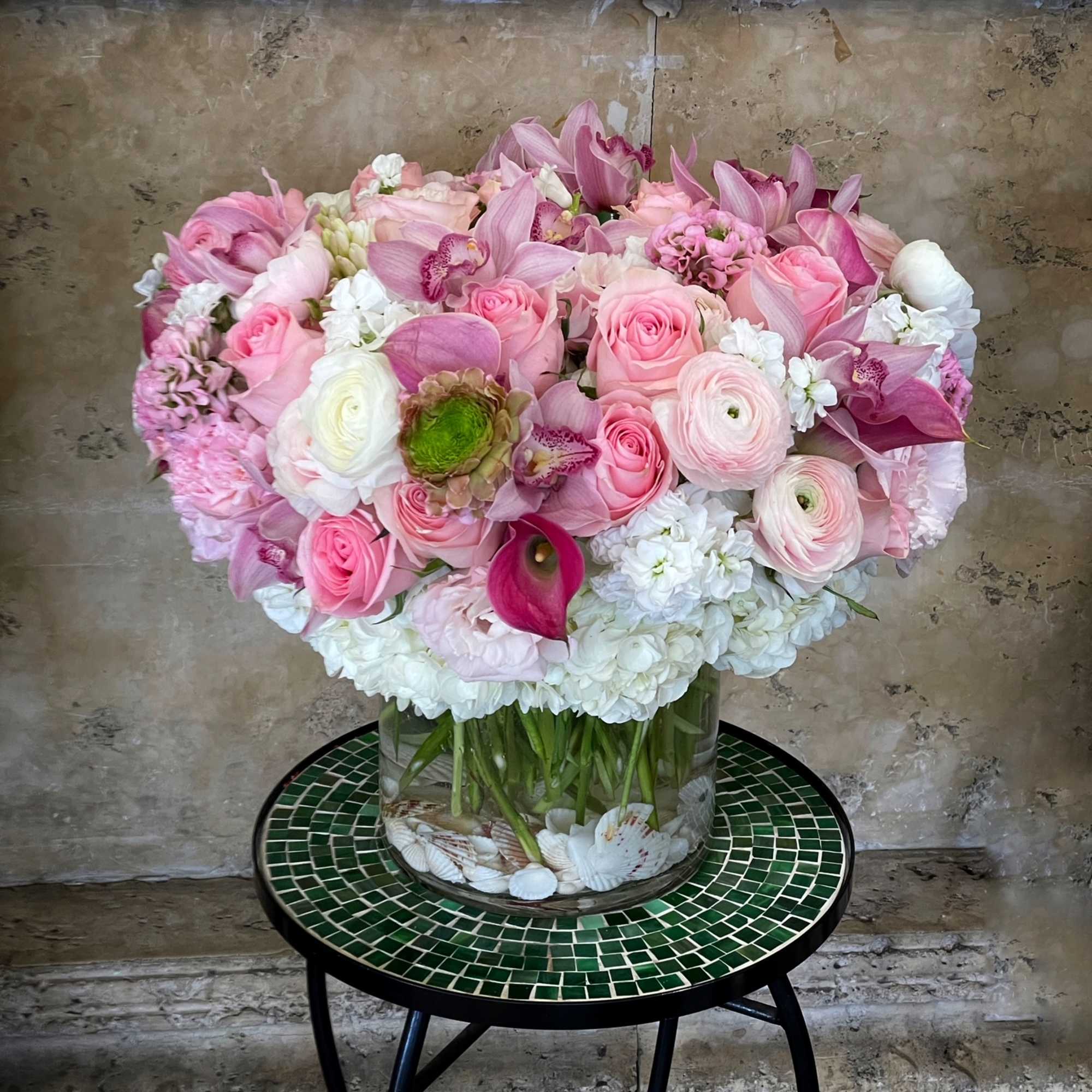 Pink Roses, Hydrangea, Cymbidium Orchid with Sea Shell in glass vase.