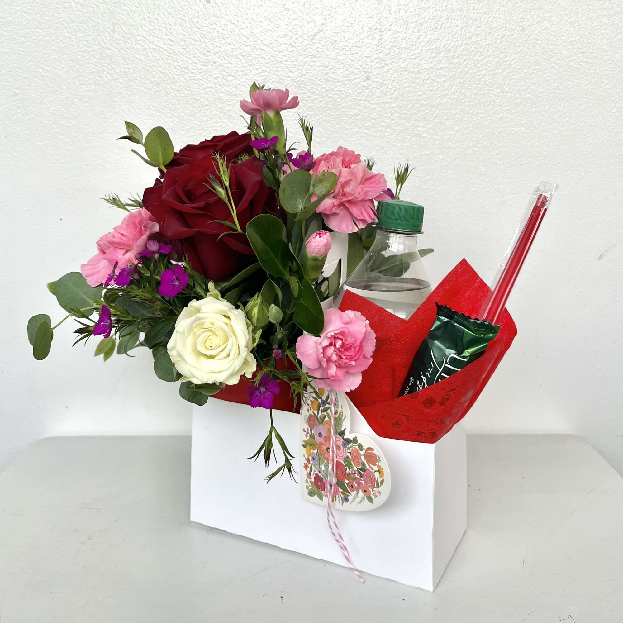 Send a sweet surprise this Valentine's Day with a charming arrangement of