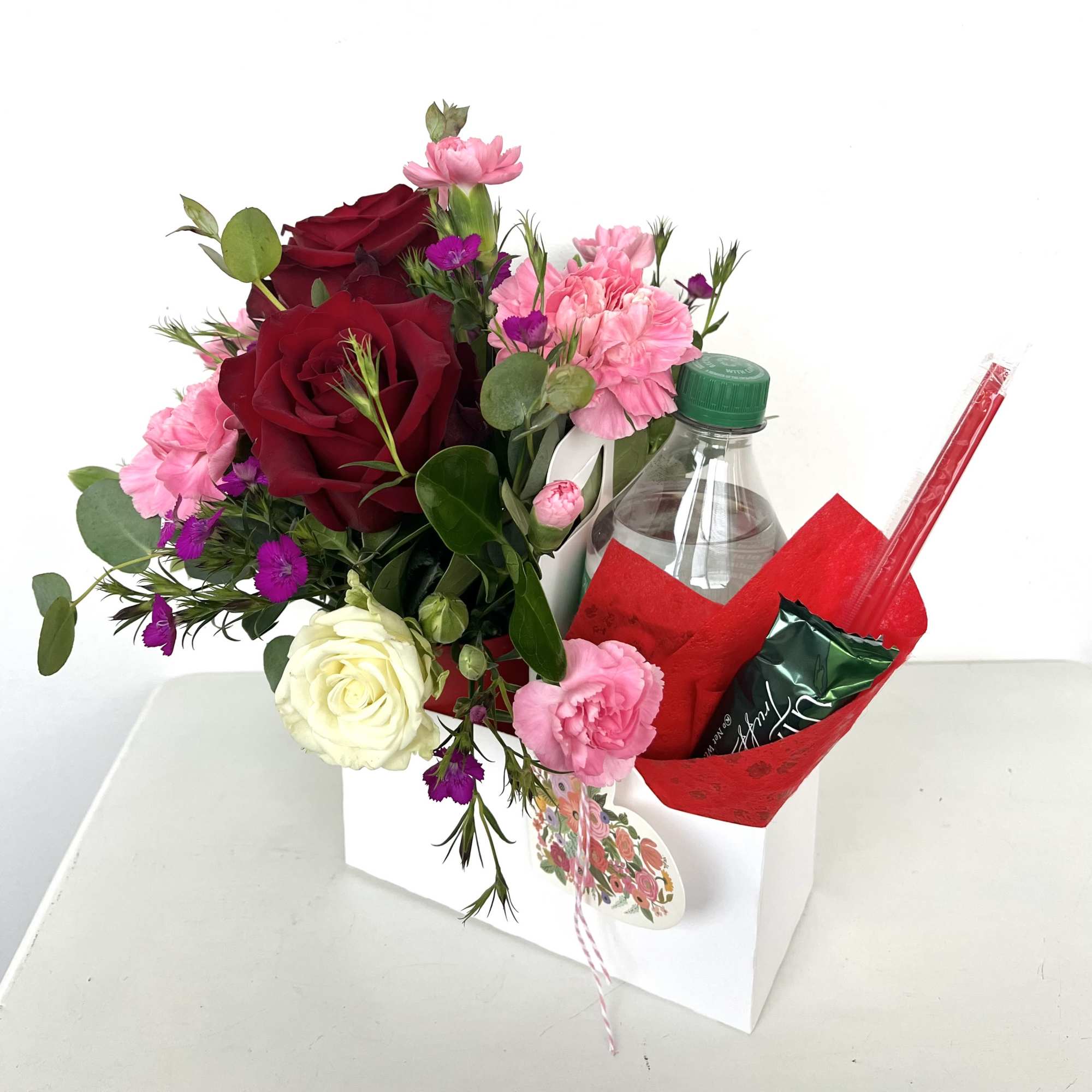 Send a sweet surprise this Valentine's Day with a charming arrangement of