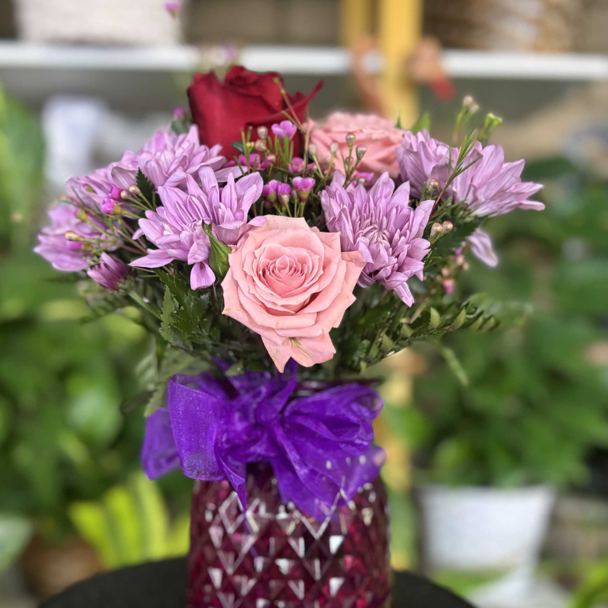 Fresh flowers in purple vase 