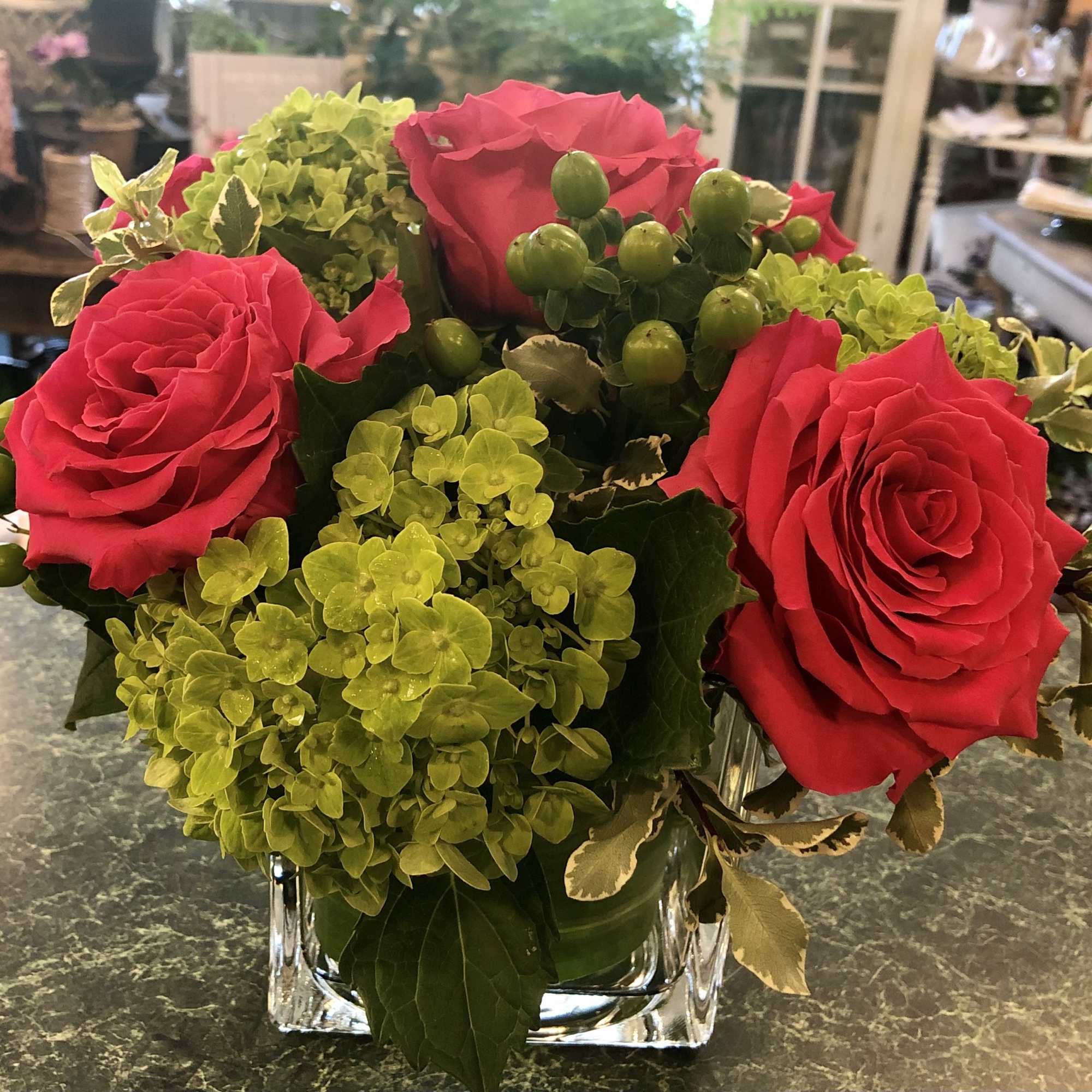 Stunning mix of Hot Pink Full Monte roses arranged with green hydrangeas