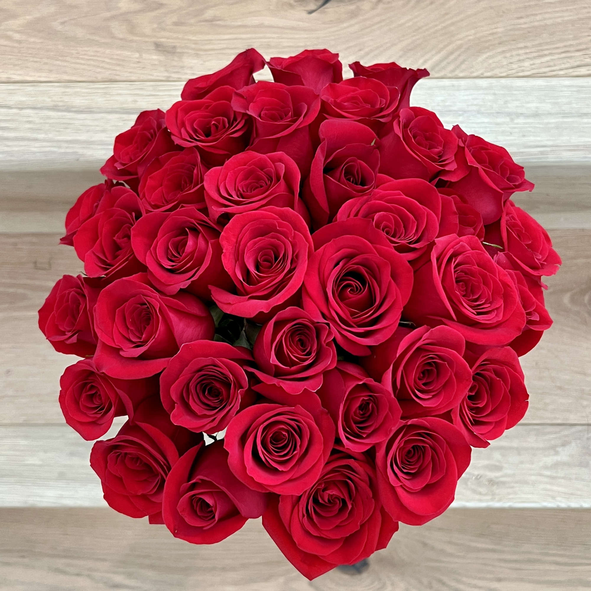 4 dozen premium long stem red roses in a premium glass vase