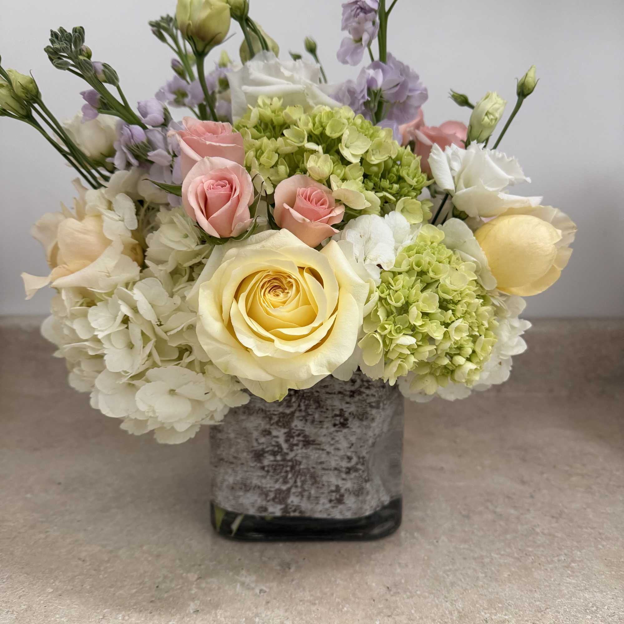 pastel colors, with pink Lisianthus , and pink spray roses, lavender stock