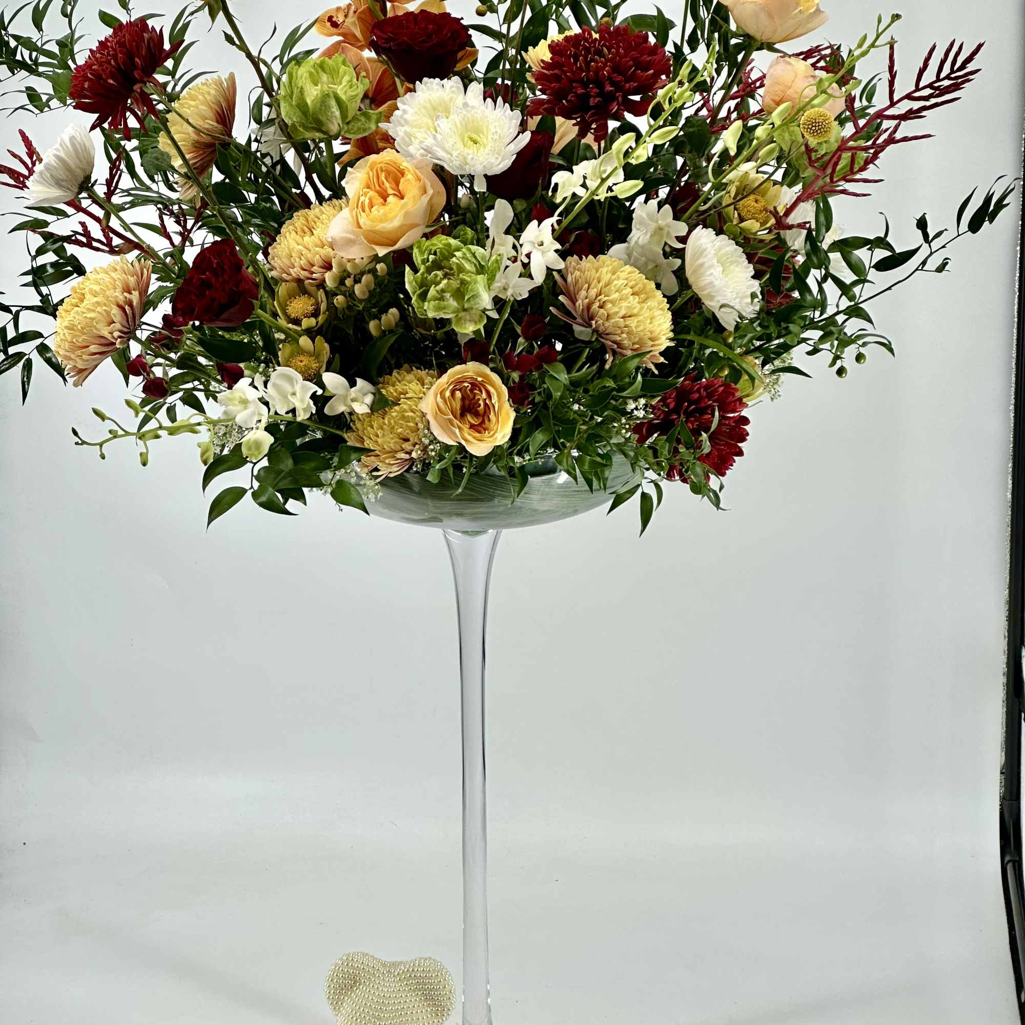 This is a Tall floral arrangement with very generous ,editorial presence -artful