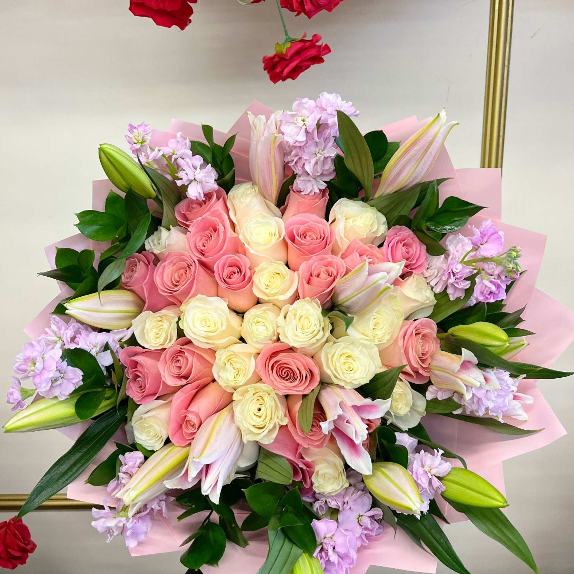 A breathtaking arrangement featuring a mix of soft pink and white roses