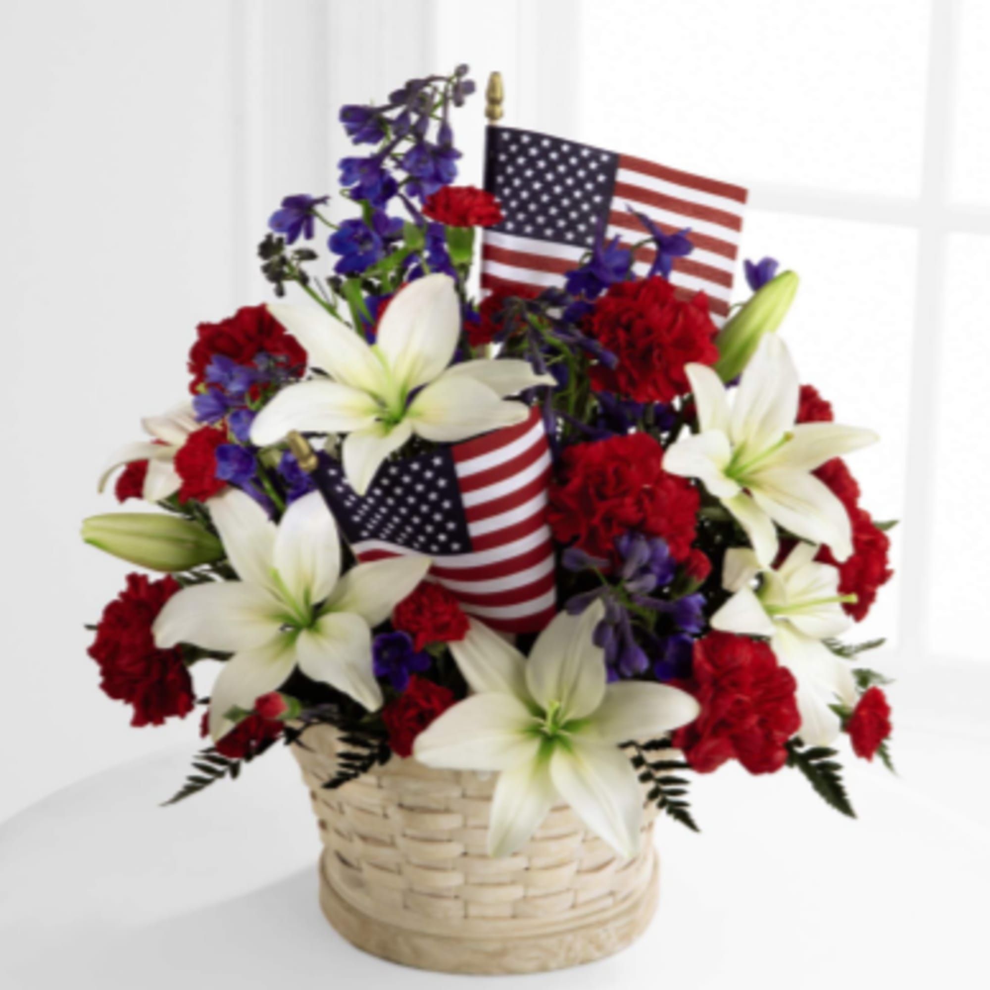 The American Glory Basket bursts with patriotic pride and heartfelt beauty. Blue