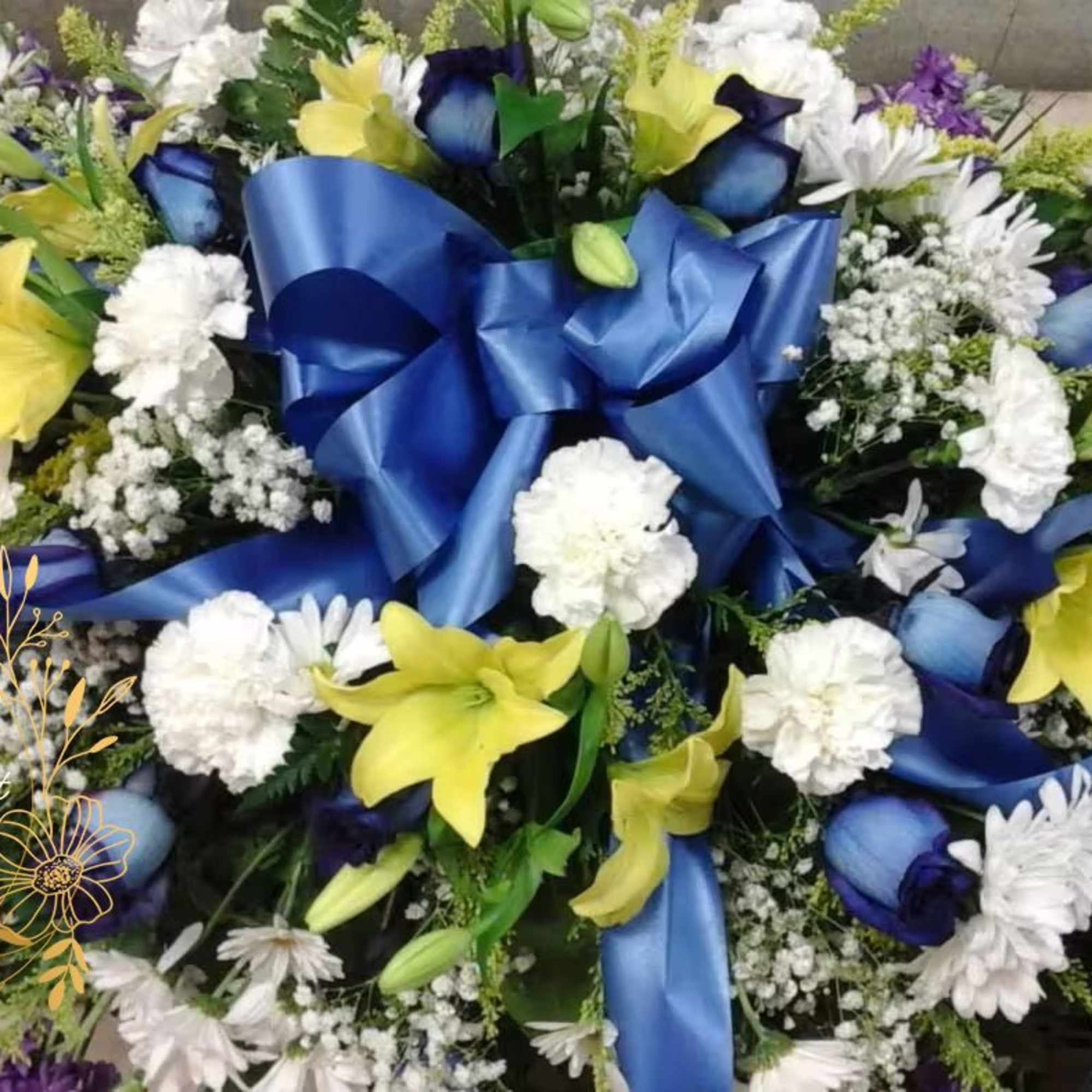 This casket make with blue roses, yellow lilies and white carnation 