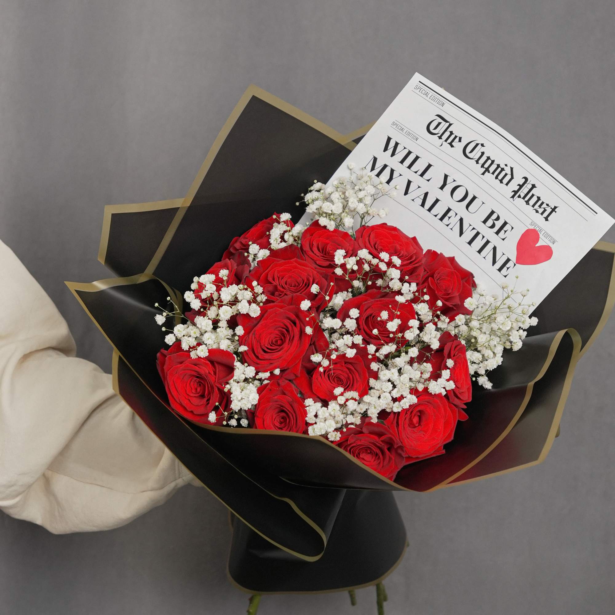 Striking bouquet featuring 12 premium red roses, imported from Ecuador, wrapped in